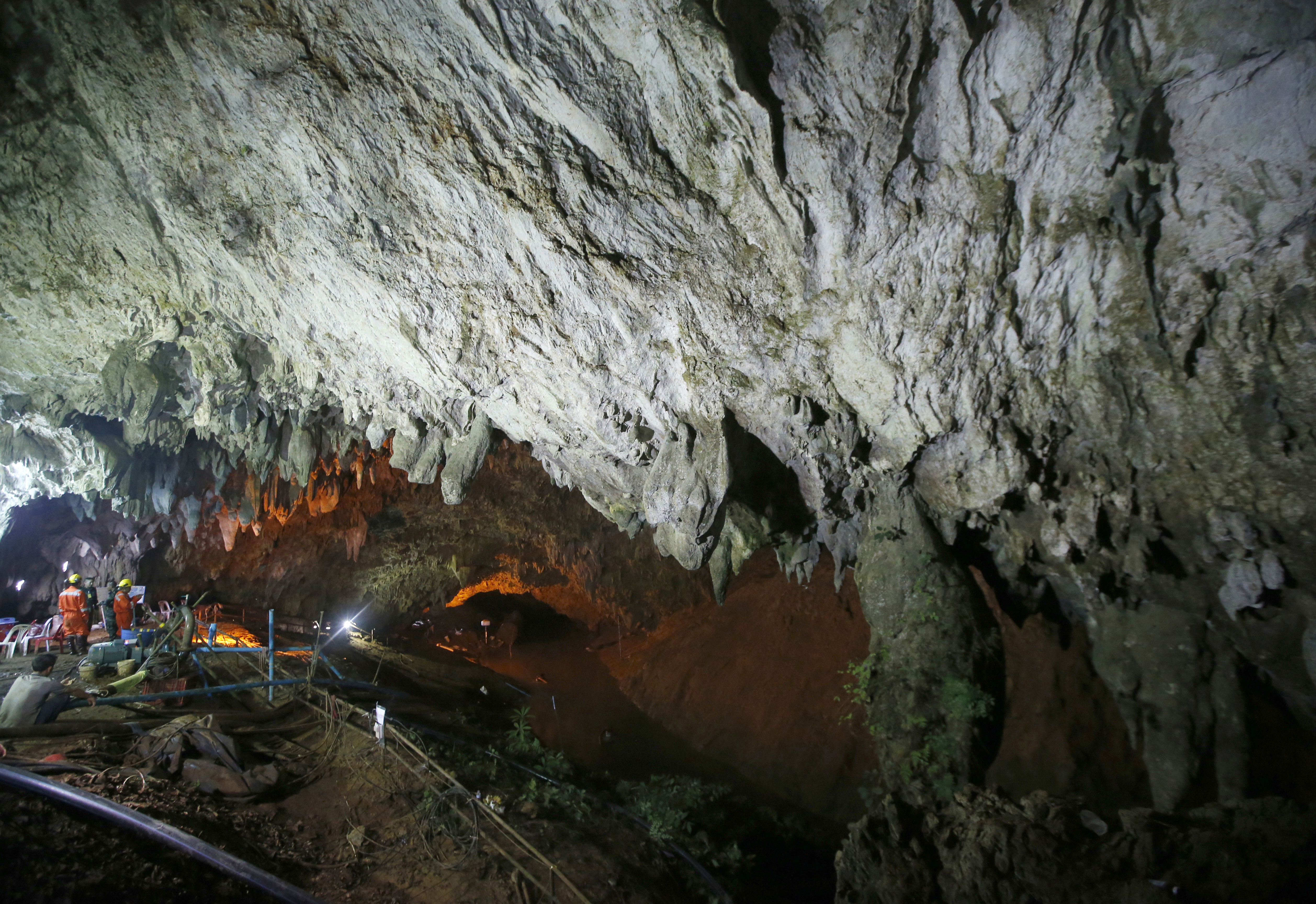 Rescuers work at the entrance to a cave complex where 12 soccer team members and their coach went missing, in Mae Sai, Chiang Rai province, in northern Thailand Saturday, June 30, 2018. Rescuers have been searching for them. (AP Photo/Sakchai Lalit)
