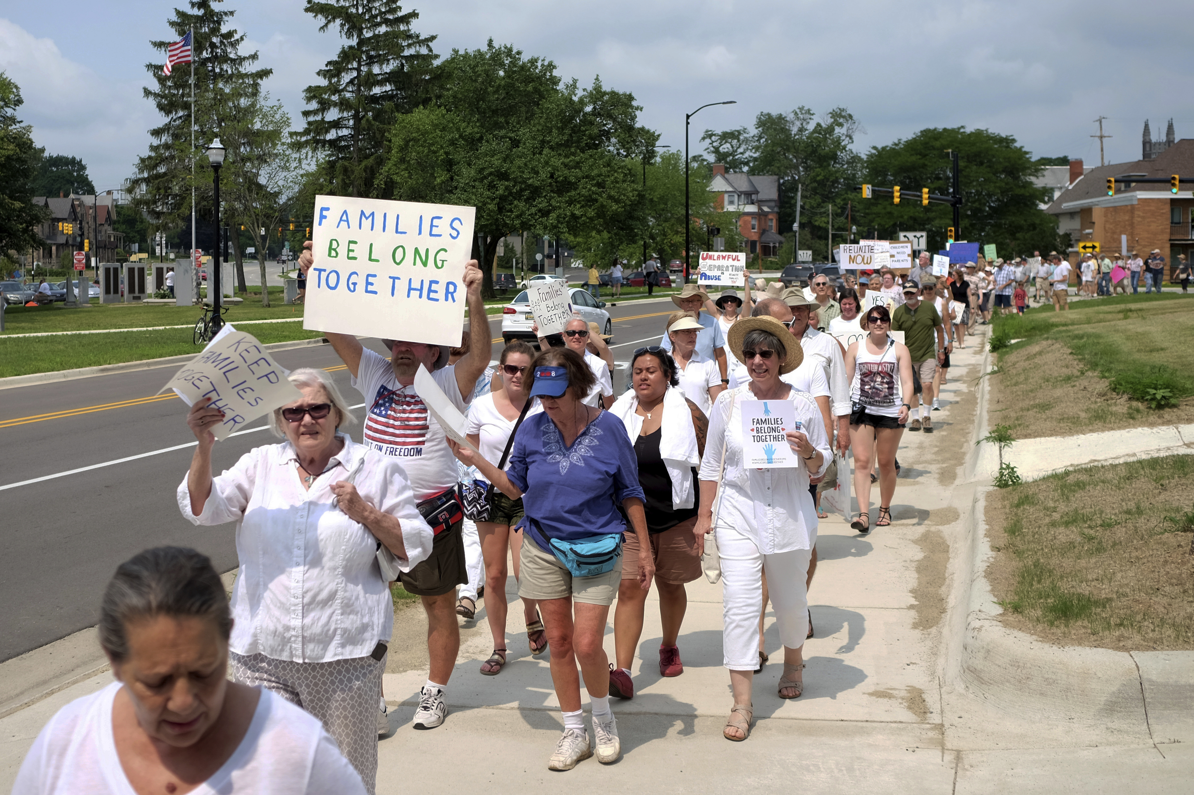 Protesters march down W. Michigan Ave. towards the Carnegie Library during a protest against separating immigrant families, Saturday, June 30, 2018, in Jackson, Mich. (Nikos Frazier/Jackson Citizen Patriot via AP)