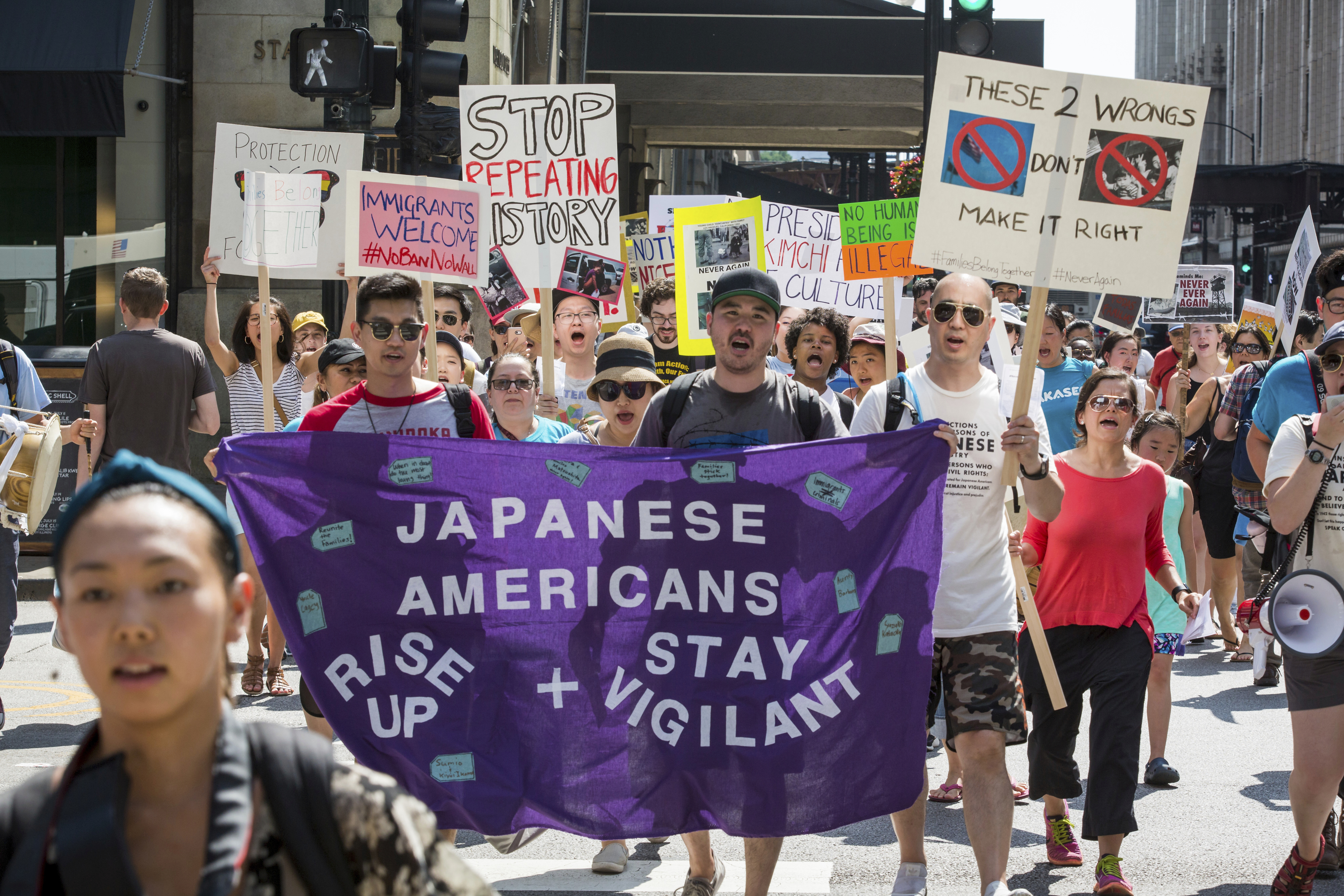 A consortium of Asian-American groups brought together by the Japanese American Service Community participate in the Families Belong Together march in Chicago on Saturday, June 30, 2018. In major cities and tiny towns, marchers gathered across America, moved by accounts of children separated from their parents at the U.S.-Mexico border, in the latest act of mass resistance against President Donald Trump's immigration policies. (James Foster/Chicago Sun-Times via AP)