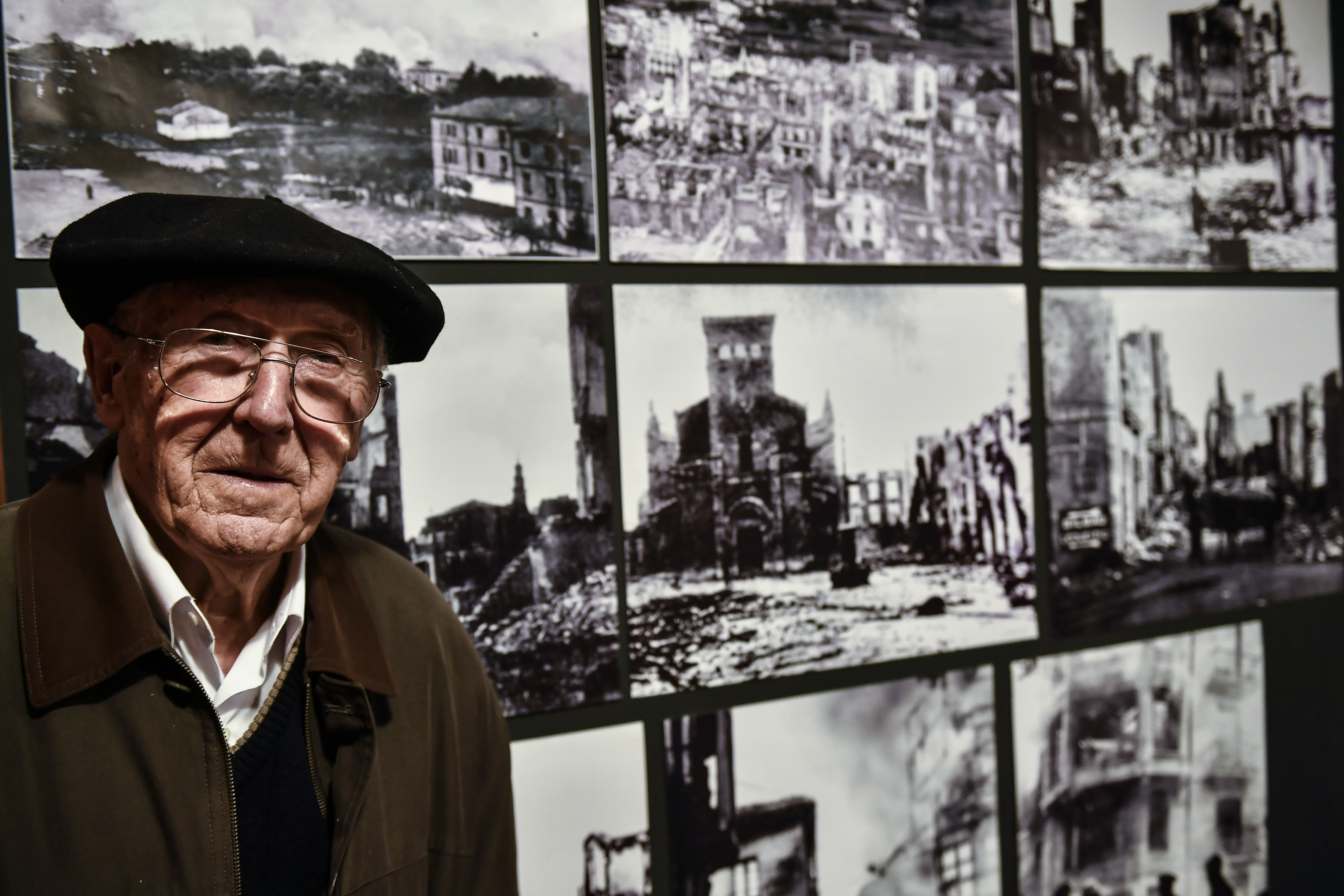 Luis Iriondo, 94 years old, a survivor of Guernica Civil War attack, poses beside old photographs of the small village destroyed, in Guernica, northern Spain, Wednesday, April 26, 2017. On this day in 1937, German and Italian warplanes raided the Basque town of Guernica during the Spanish Civil War; estimates of the number of people killed vary from the hundreds to the thousands. The carnage has ever since stood as a symbol of man's cruelty to his fellow man, immortalized in Pablo Picasso's immense and powerful painting, one of the most iconic works of art of the 20th century. (AP Photo/Alvaro Barrientos)