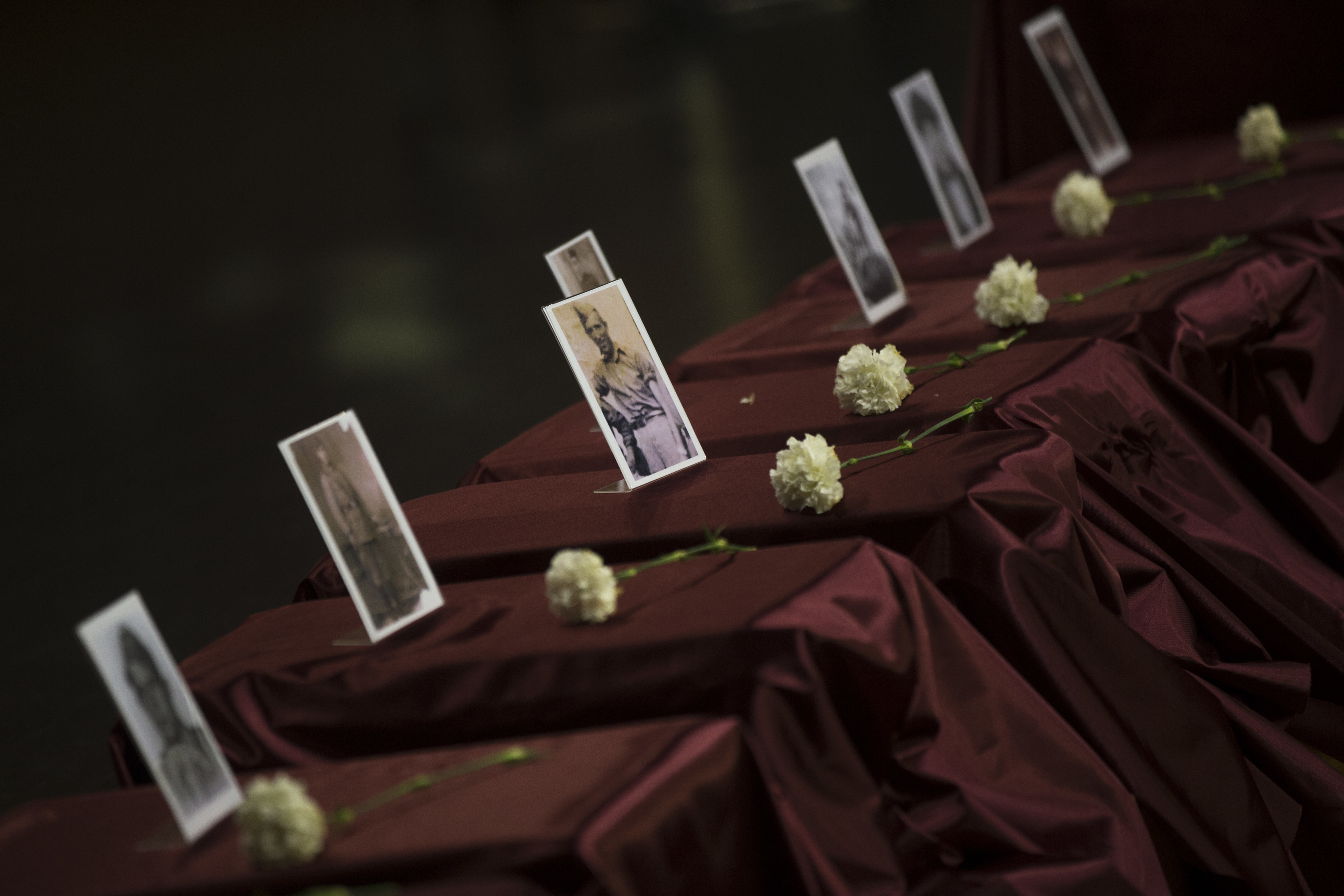 Boxes containing the remains of 22 people killed by a militia of former Spanish dictator Francisco Franco between 1939 and 1940, are honored in a ceremony in Guadalajara, Spain on Saturday, May 19, 2018. Exhumed from a mass grave at the Guadalajara cemetery between 2016 and 2017, the remains were returned to relatives. (AP Photo/Francisco Seco)