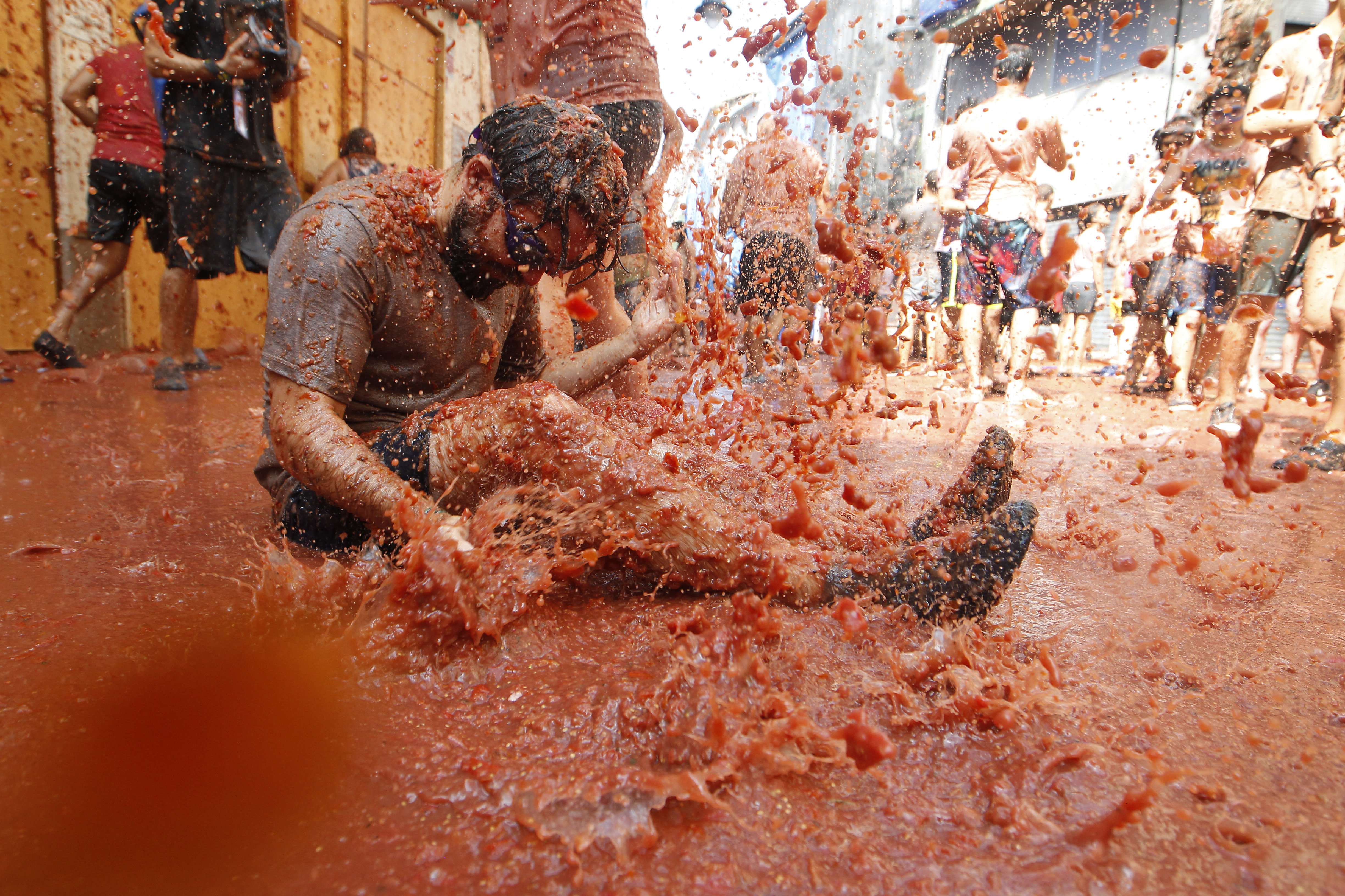 Revelers throw tomatoes at each other, during the annual 