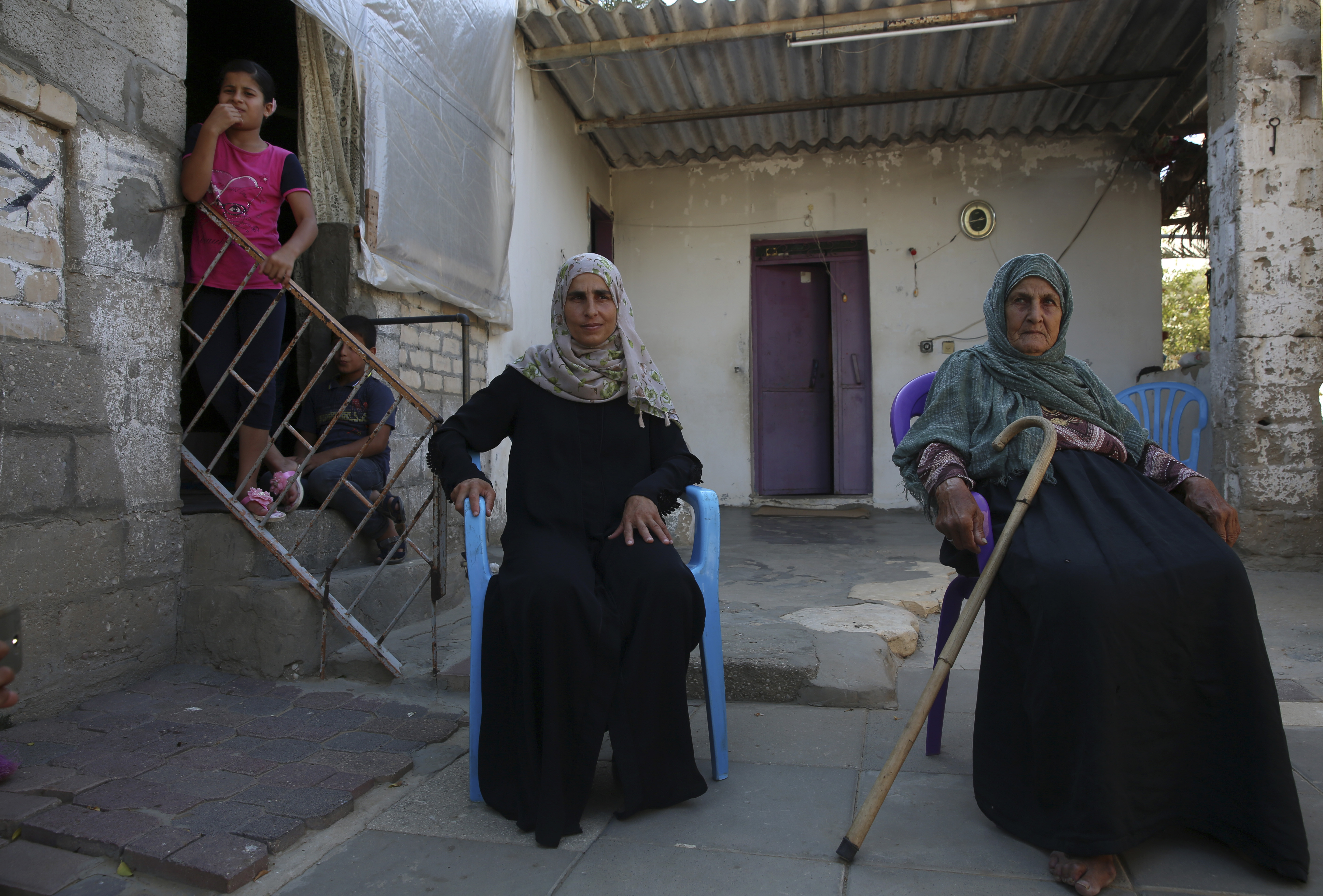In this Friday, Aug. 24, 2018 photo, Palestinian paramedic Asmaa Qudih and her mother's Fatma sit at their family house in Abassan, east of Khan Younis City, southern Gaza Strip before she leaves to treat the protesters wounded of a protest near the Gaza Strip border with Israel. Qudih acknowledges the weekly routine is terrifying, but a mix of national pride, religious devotion and professional ambition drives her and other medics to risk their lives each week. (AP Photo/Adel Hana)