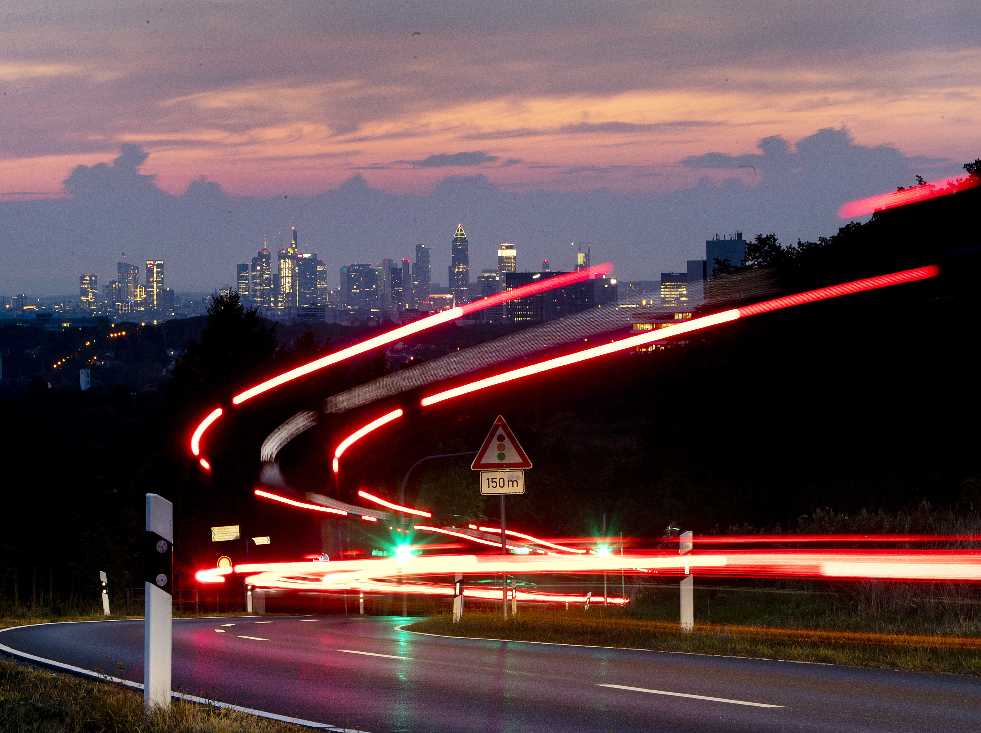 Long time exposure shows commuters driving to the city of Frankfurt (background), Germany, Thursday, Sept. 13, 2018. (AP Photo/Michael Probst)