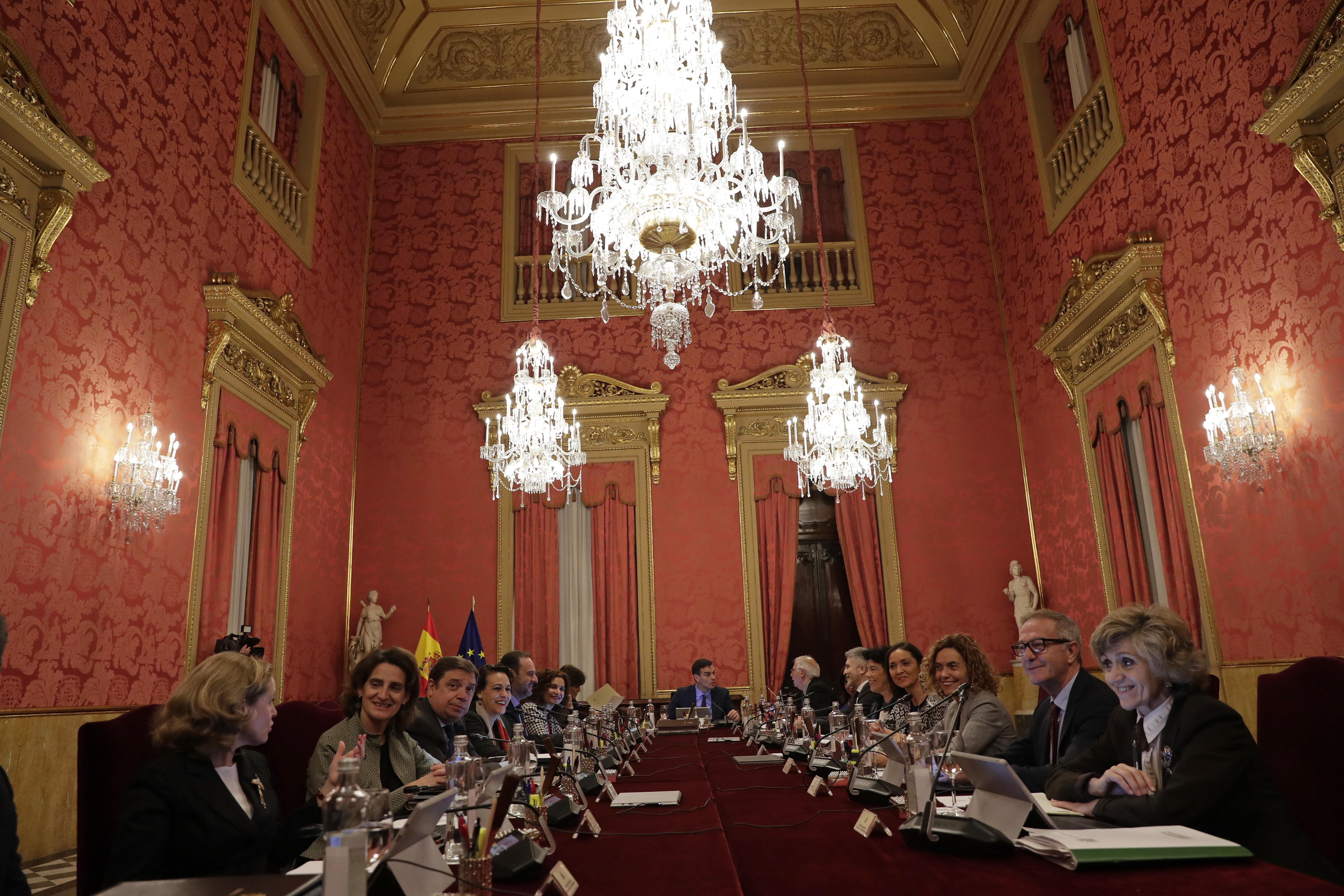Spain's Prime Minister Pedro Sanchez, centre rear, presides over a weekly Cabinet meeting with government ministers held in Barcelona, Spain, Friday, Dec. 21, 2018. Catalan authorities say pro-independence protesters angry about Spain's Cabinet holding a meeting in Barcelona have blocked a major highway and dozens of roads, disrupting traffic to and from the city. (AP Photo/Manu Fernandez)