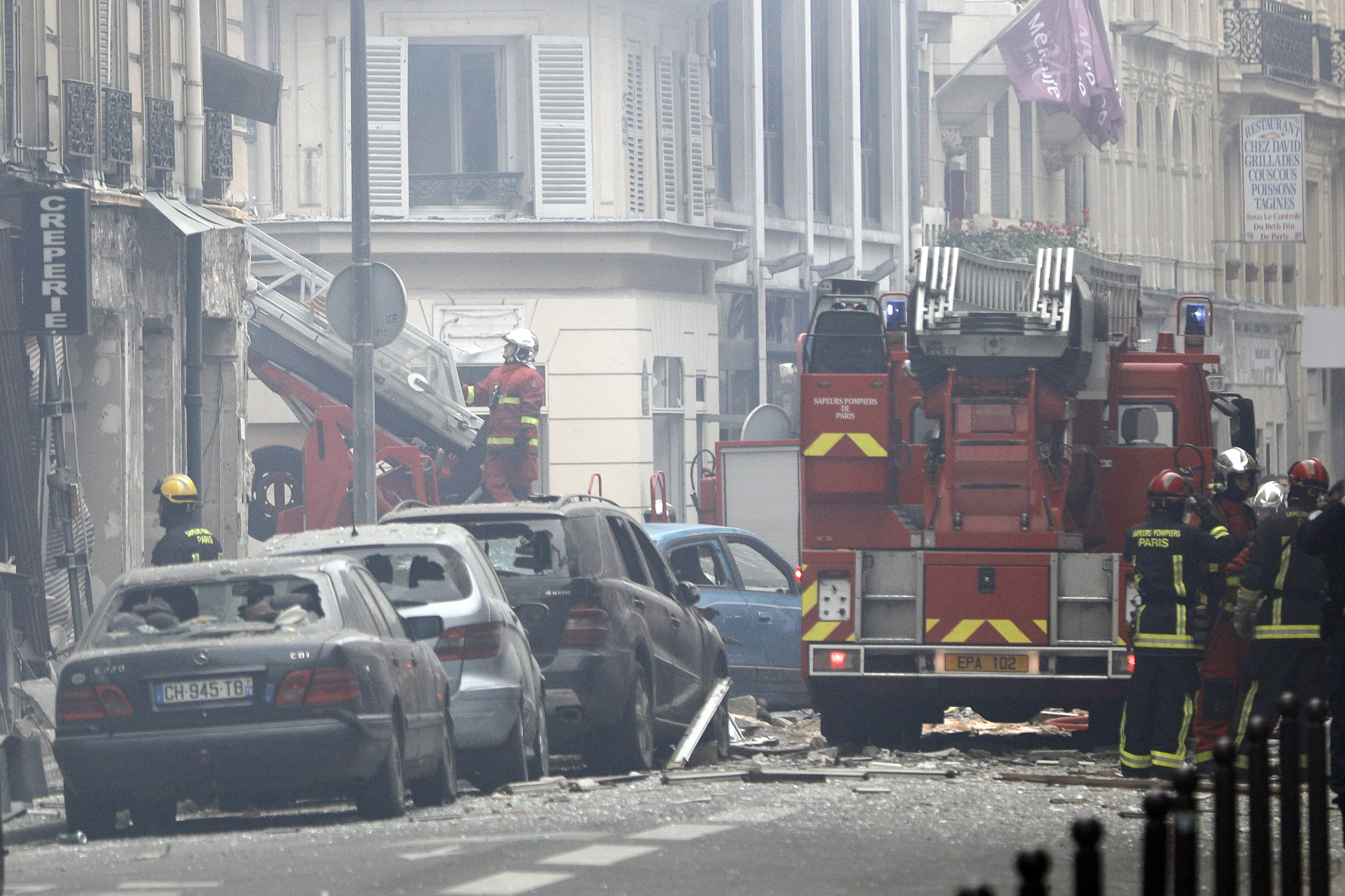 Firefighters work at the scene of a gas leak explosion in Paris, France, Saturday, Jan. 12, 2019. Paris police say several people have been injured in an explosion and fire at a bakery believed caused by a gas leak. (AP Photo/Kamil Zihnioglu)