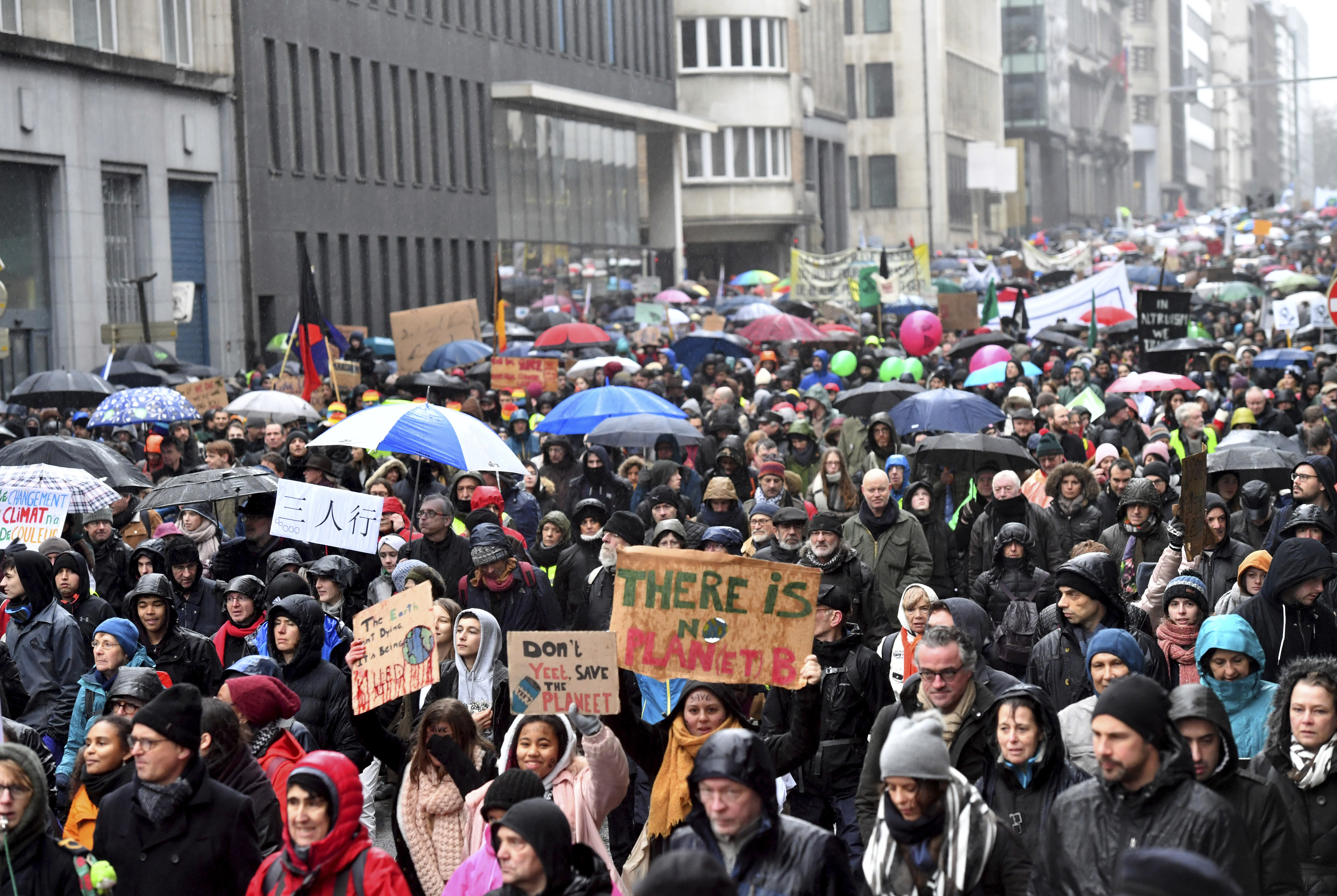 Protestors hold banners as they march during a Rise for the Climate demonstration in Brussels, Sunday, Jan. 27, 2019. (AP Photo/Geert Vanden Wijngaert)