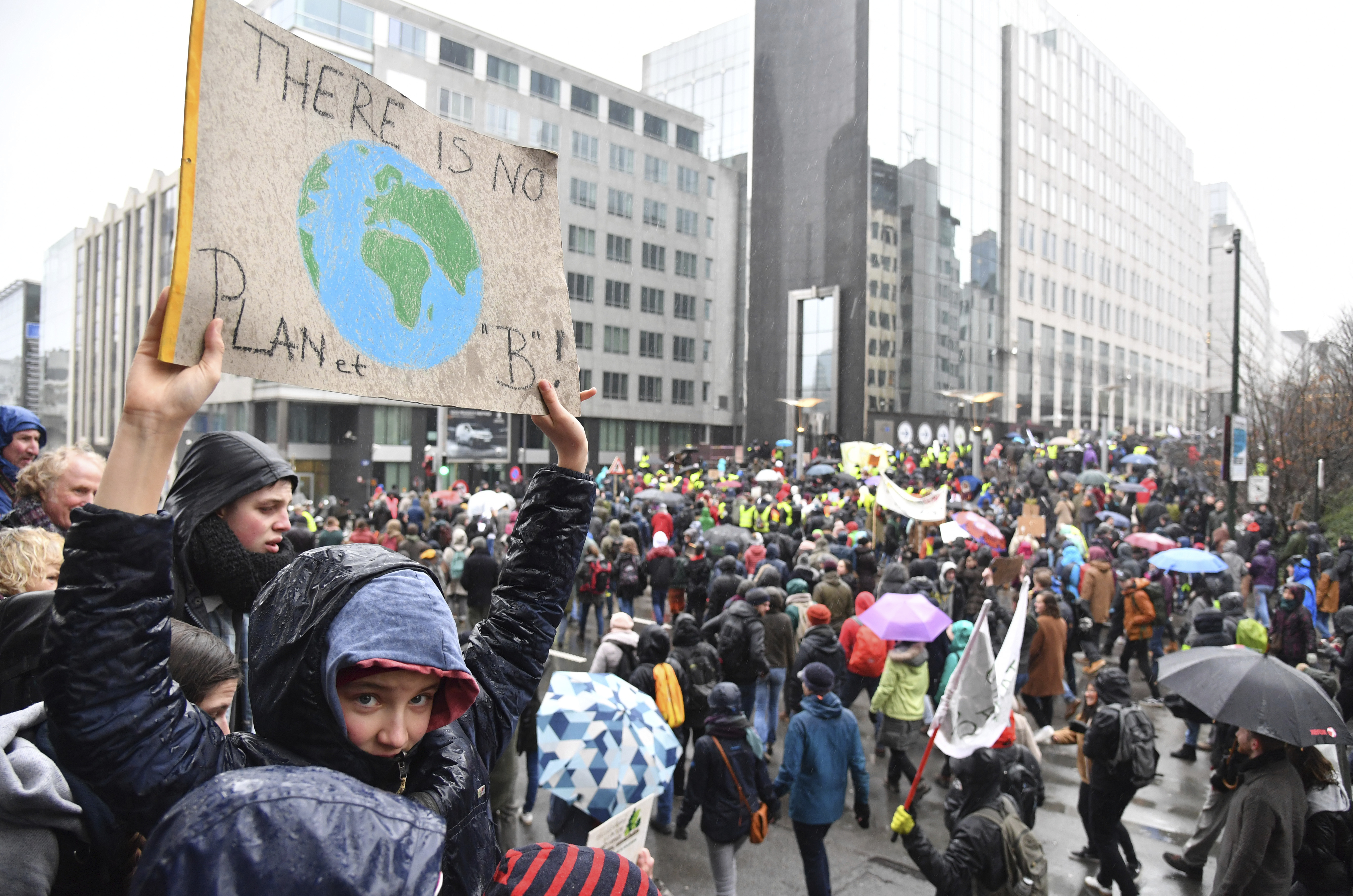 Protestors hold banners as they march during a Rise for the Climate demonstration in Brussels, Sunday, Jan. 27, 2019. (AP Photo/Geert Vanden Wijngaert)