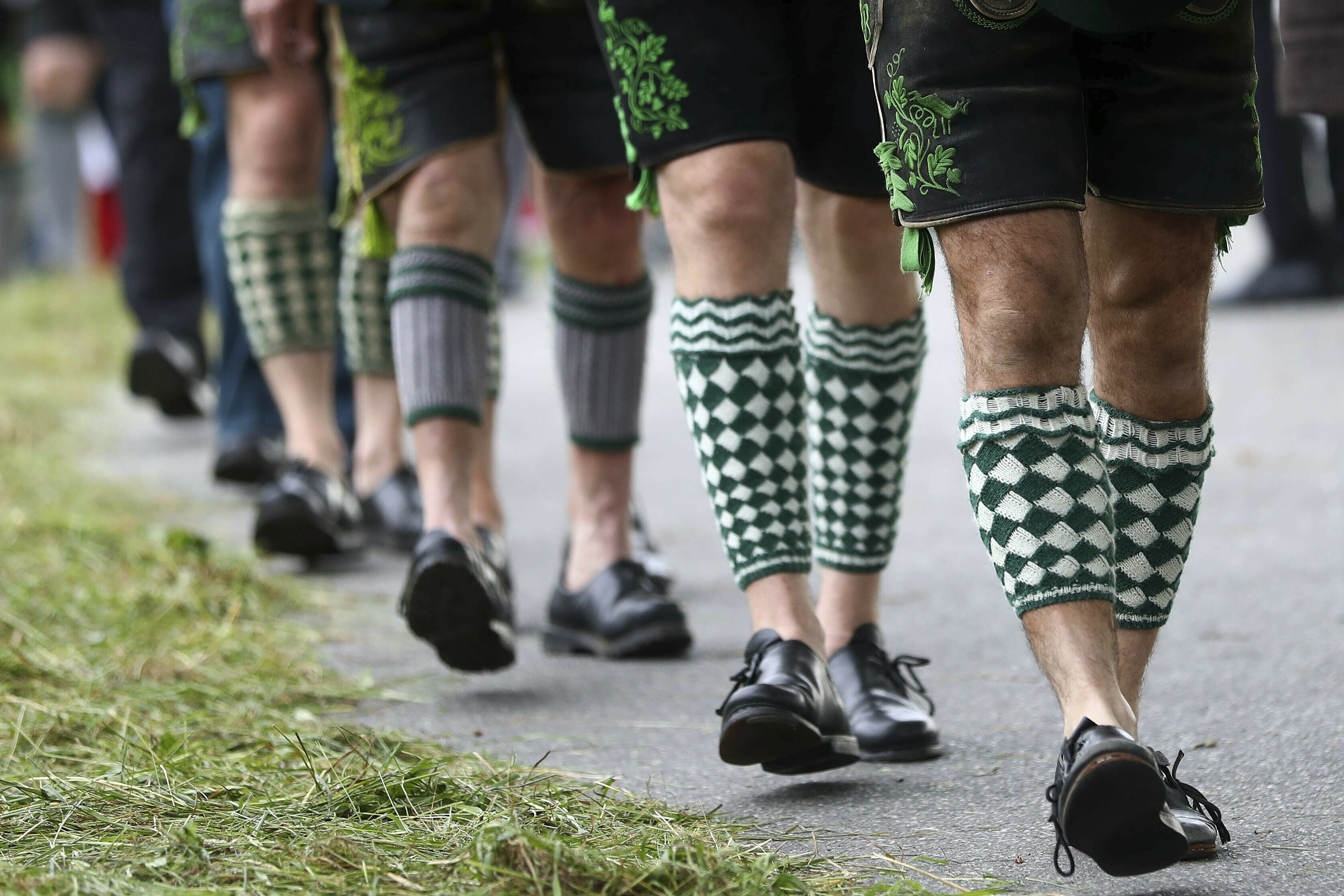 Men dressed in traditional clothes start for a Corpus Christi procession at lake Staffelsee in Seehausen near Murnau, Germany, Thursday, June 20, 2019. (AP Photo/Matthias Schrader)