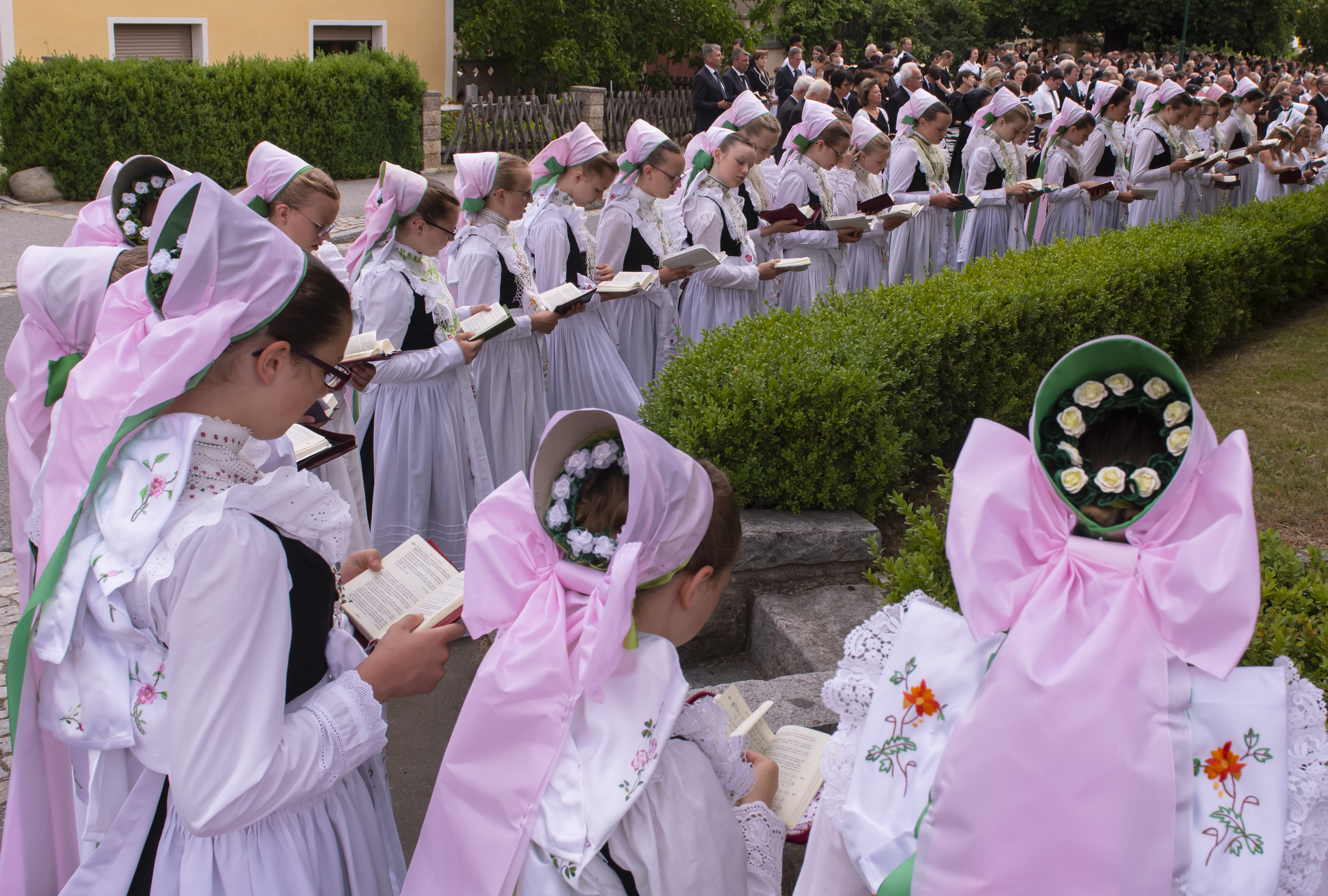 Children dressed in the traditional clothes of the Sorbs attend a Corpus Christi procession in Crostwitz, Germany, Thursday, June 20, 2019. The catholic faithful Sorbs are acknowledged as a national minority near the German-Polish border with their own language in eastern Germany. The procession to commemorate the solemnity of the body and blood of Christ has been a tradition in Lusatia (Lausitz) region. (AP Photo/Jens Meyer)