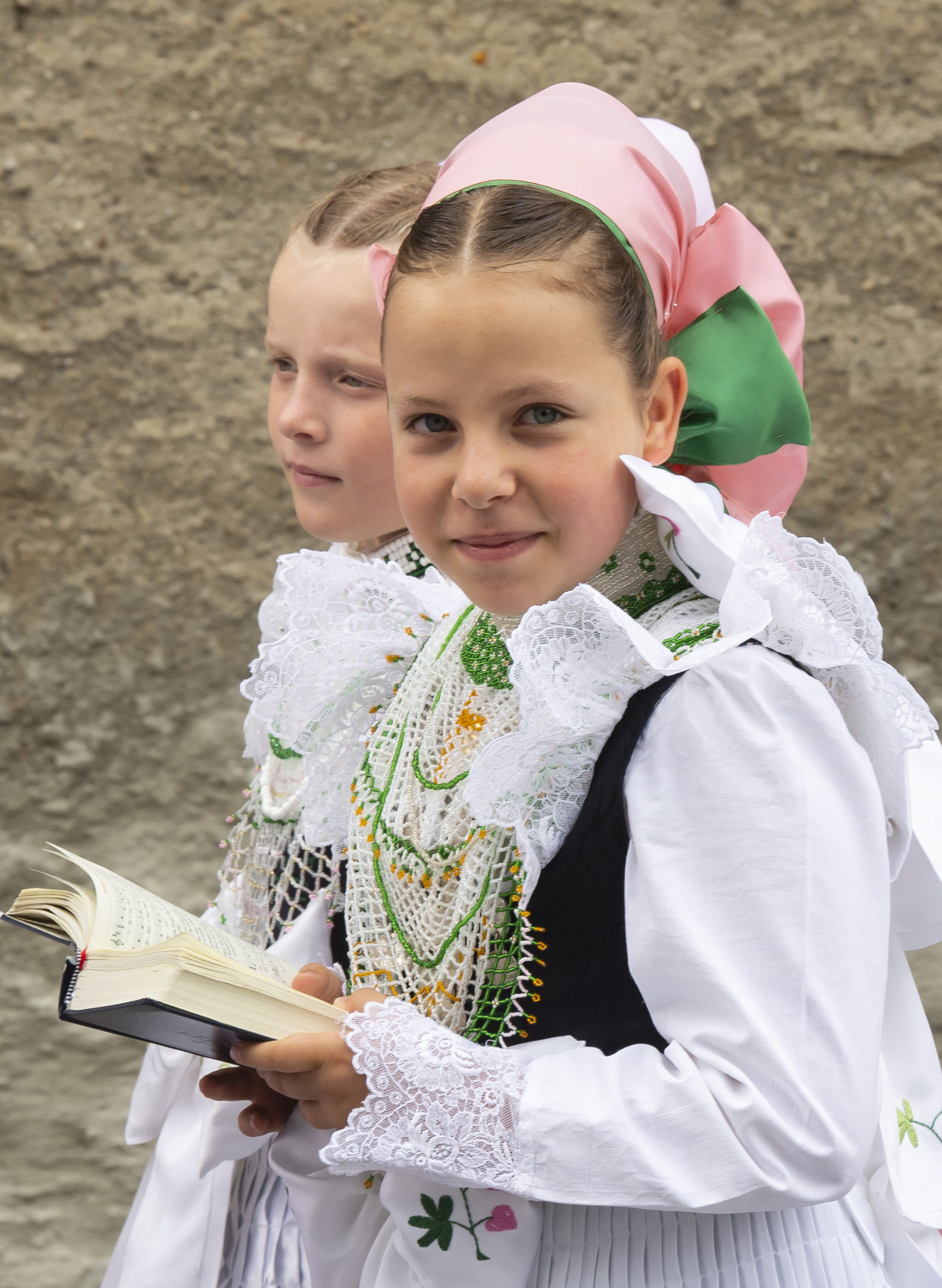Children dressed in the traditional clothes of the Sorbs attend a Corpus Christi procession in Crostwitz, Germany, Thursday, June 20, 2019. The catholic faithful Sorbs are acknowledged as a national minority near the German-Polish border with their own language in eastern Germany. The procession to commemorate the solemnity of the body and blood of Christ has been a tradition in Lusatia (Lausitz) region. (AP Photo/Jens Meyer)