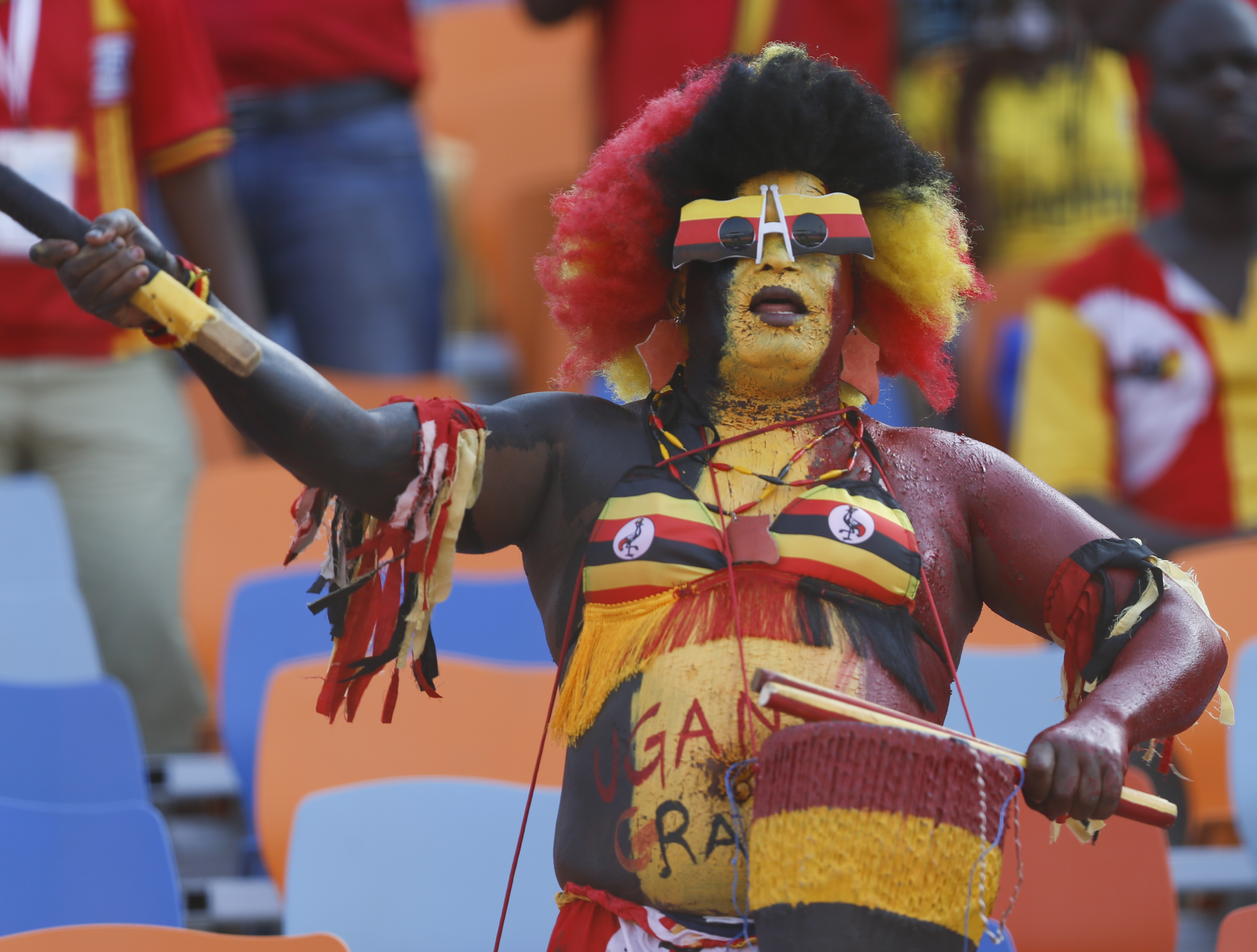 Ugandan fan cheers before the African Cup of Nations group A soccer match between DR Congo and Uganda at Cairo International Stadium in Cairo, Egypt, Saturday, June 22, 2019. (AP Photo/Ariel Schalit)