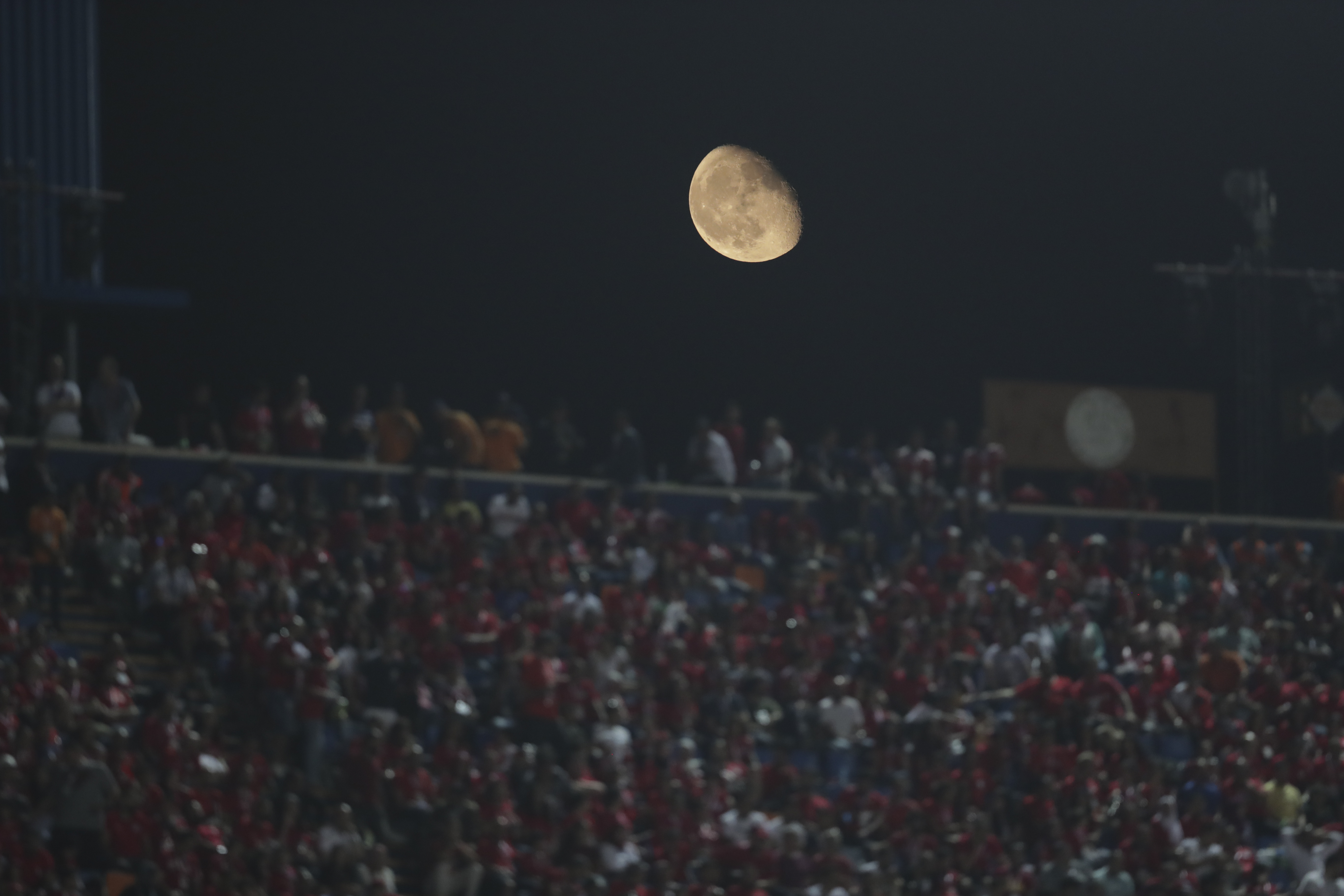Moon rises above the stadium during the group A soccer match between Egypt and Zimbabwe at the Africa Cup of Nations at Cairo International Stadium in Cairo, Egypt, Friday, June 21, 2019. (AP Photo/Hassan Ammar)