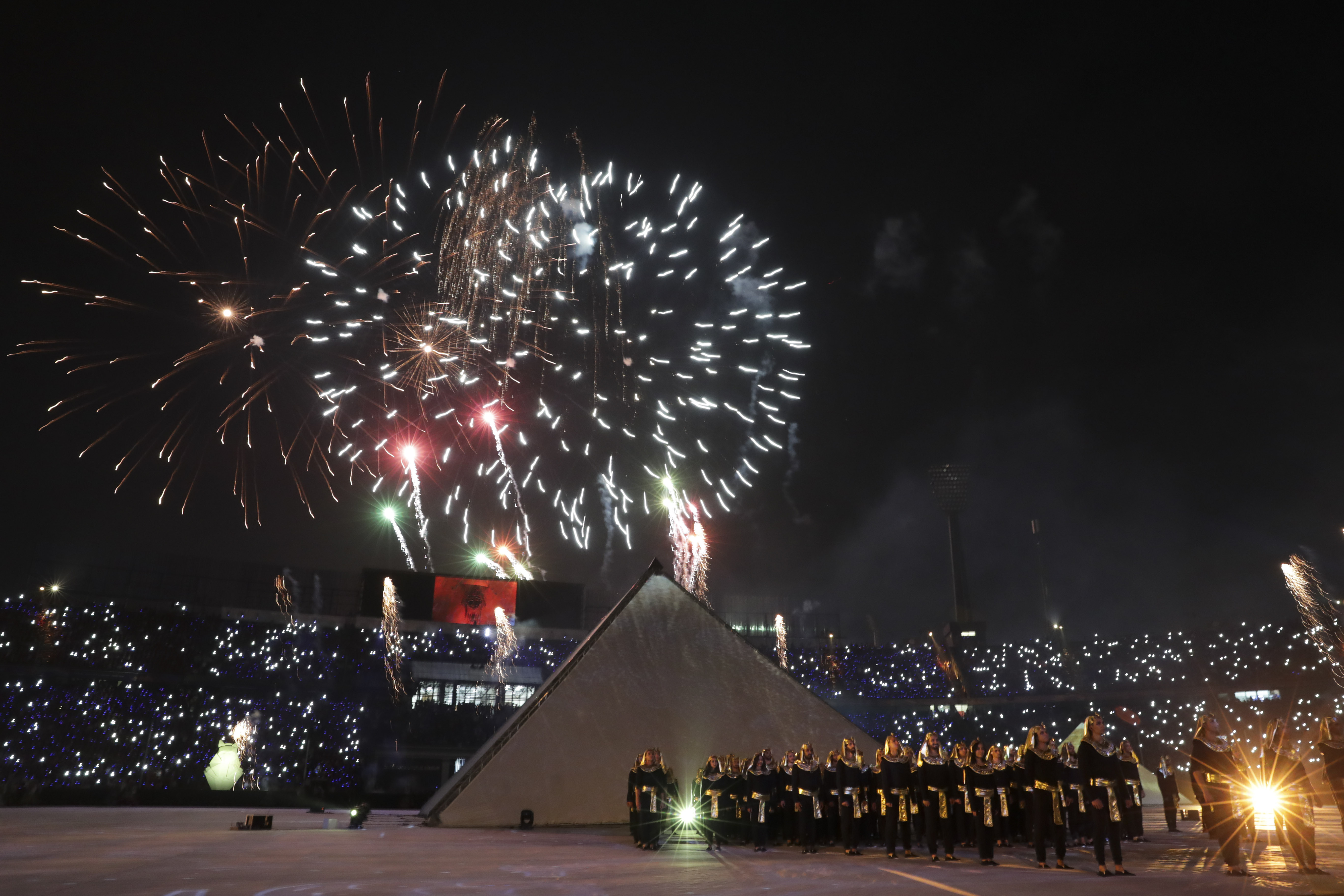 Fireworks are seen during the opening ceremony before the group A soccer match between Egypt and Zimbabwe opening match of the Africa Cup of Nations at Cairo International Stadium in Cairo, Egypt, Friday, June 21, 2019. (AP Photo/Hassan Ammar)