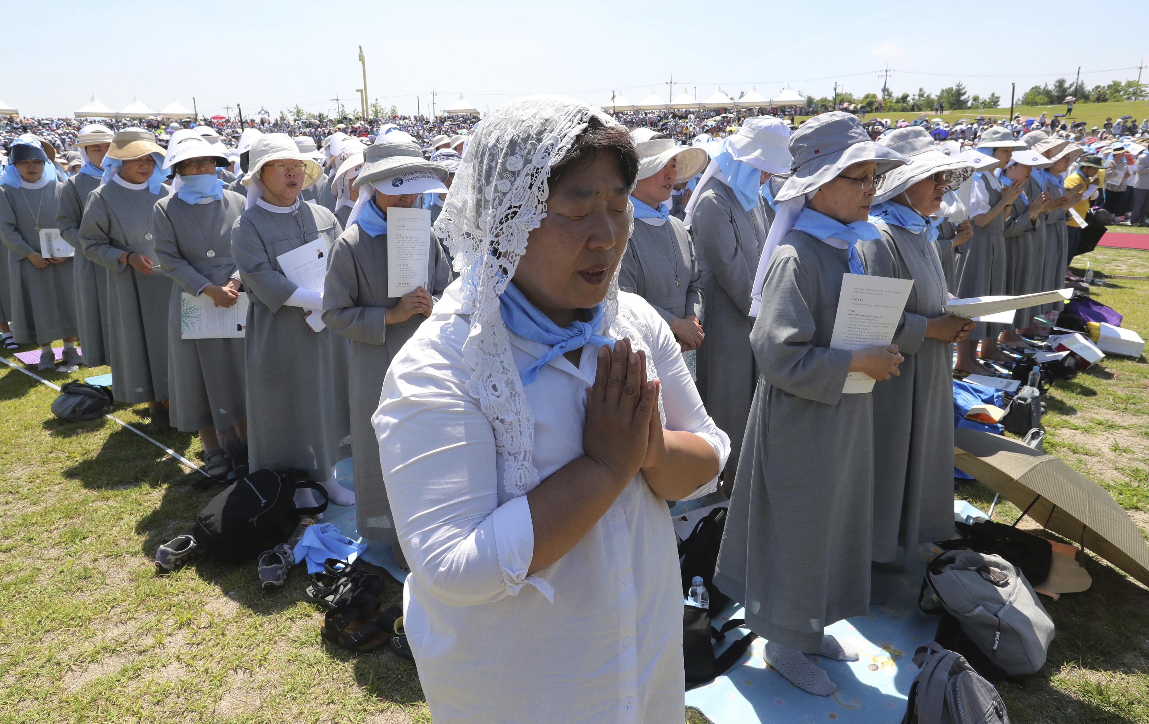 A South Korean Catholic believer prays wishing for peace on the Korean Peninsula during a service to mark the 69th anniversary of the outbreak of the Korean War at the Imjingak Pavilion, near the demilitarized zone of Panmunjom, in Paju, South Korea, Tuesday, June 25, 2019. South Korea and North Korea fought a devastating three-year war in the early 1950s that ended with an armistice, not a peace treaty. (AP Photo/Ahn Young-joon)