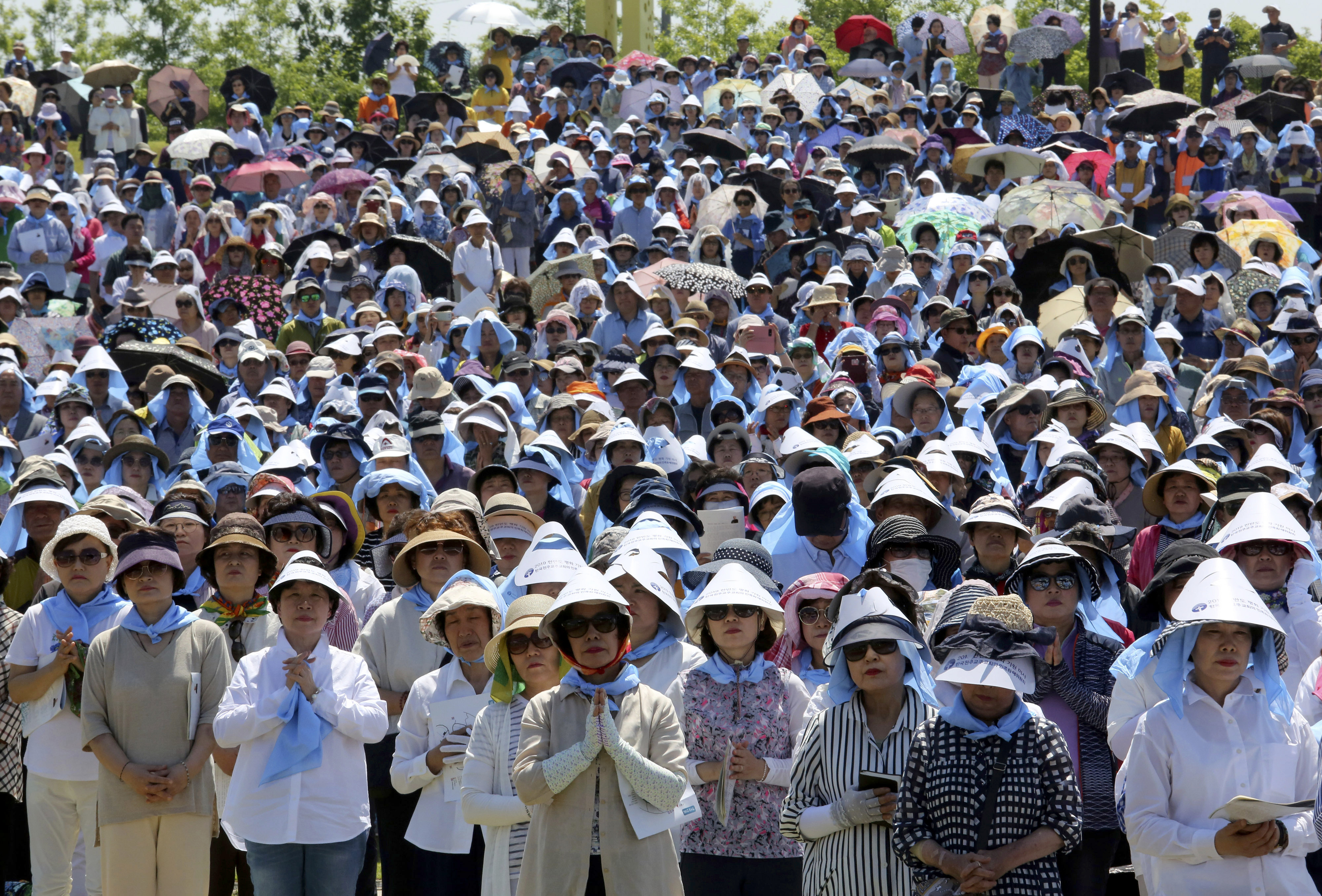 South Korean Catholic believers pray wishing for peace on the Korea peninsula during a service to mark the 69th anniversary of the outbreak of the Korean War at the Imjingak Pavilion, near the demilitarized zone of Panmunjom, in Paju, South Korea, Tuesday, June 25, 2019. South Korea and North Korea fought a devastating three-year war in the early 1950s that ended with an armistice, not a peace treaty. (AP Photo/Ahn Young-joon)
