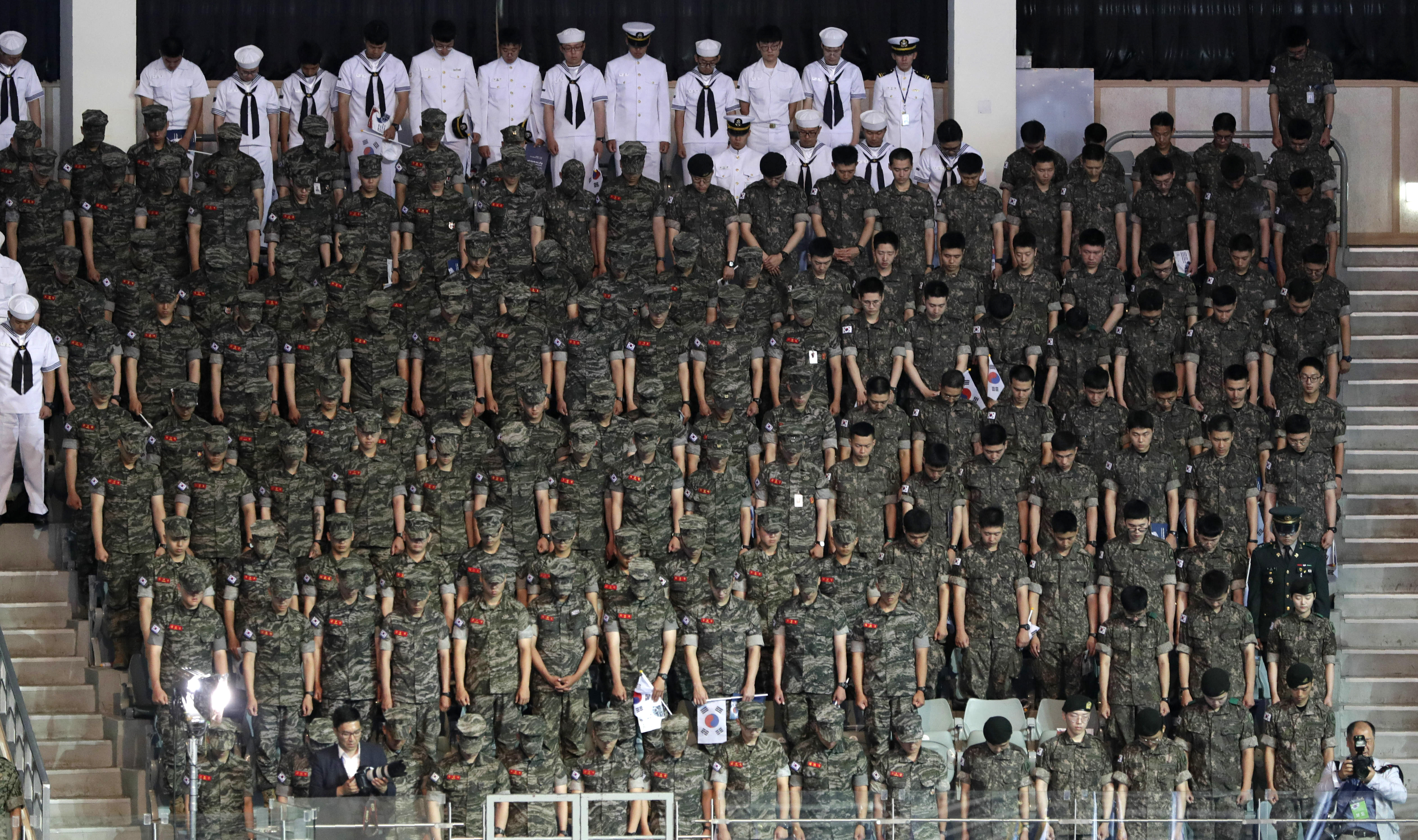 South Korean soldiers pay a silent tribute during a ceremony to mark the 69th anniversary of the outbreak of the Korean War in Seoul, South Korea, Tuesday, June 25, 2019. South Korea and North Korea fought a devastating three-year war in the early 1950s that ended with an armistice, not a peace treaty. (AP Photo/Lee Jin-man)