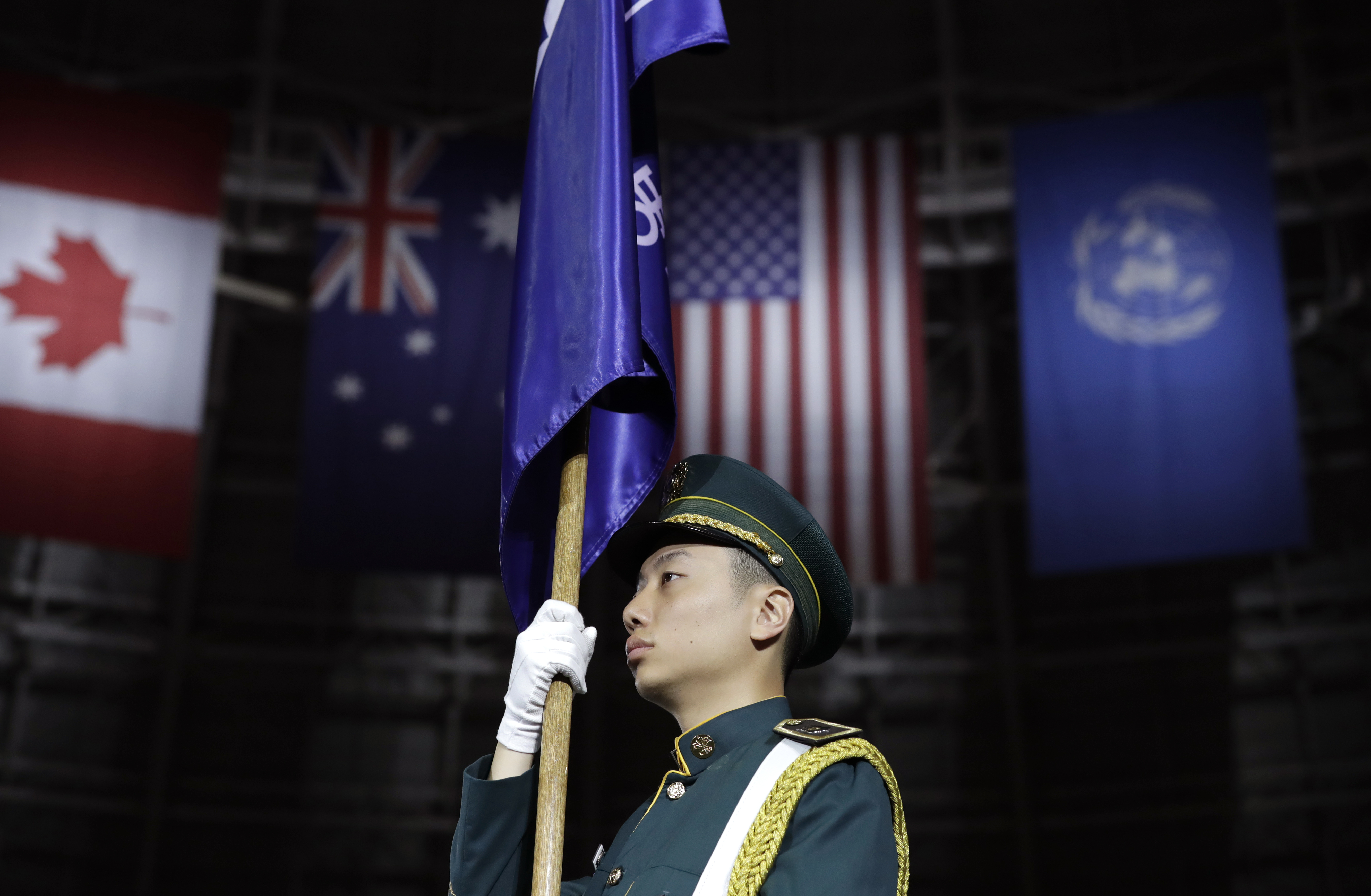 A South Korean honor guard soldier holds flag before a ceremony to mark the 69th anniversary of the outbreak of the Korean War in Seoul, South Korea, Tuesday, June 25, 2019. South Korea and North Korea fought a devastating three-year war in the early 1950s that ended with an armistice, not a peace treaty. (AP Photo/Lee Jin-man)