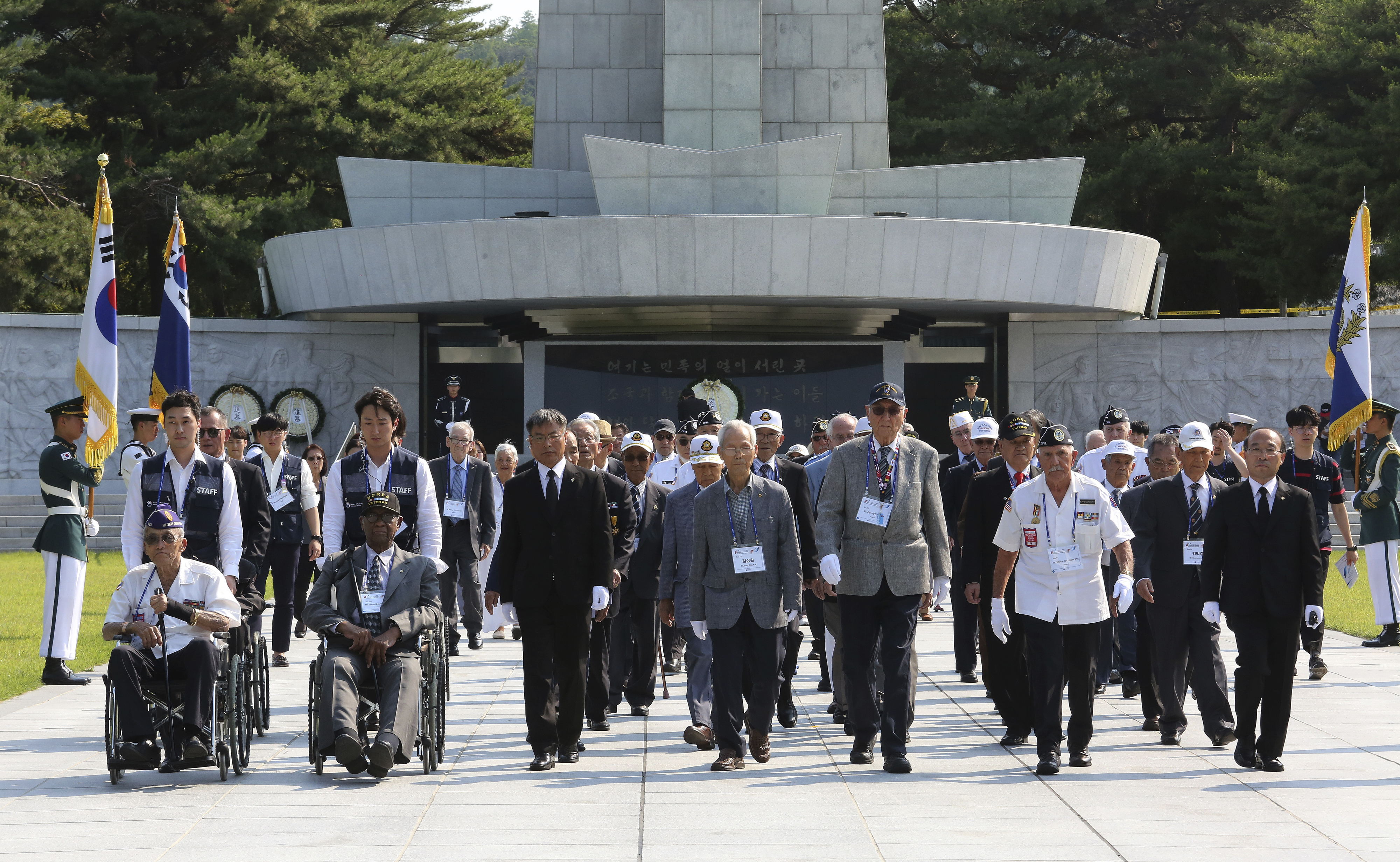 South Korean and U.S. veterans of the Korean War visit on the eve of the 69th anniversary of the outbreak of the Korean War at the National Cemetery in Seoul, South Korea, Monday, June 24, 2019. 62 U.S. war veterans and their families, along with 20 Korean veterans and their families residing overseas, arrived on Sunday, June 23, here for a six-day visit to mark the anniversary. (AP Photo/Ahn Young-joon)