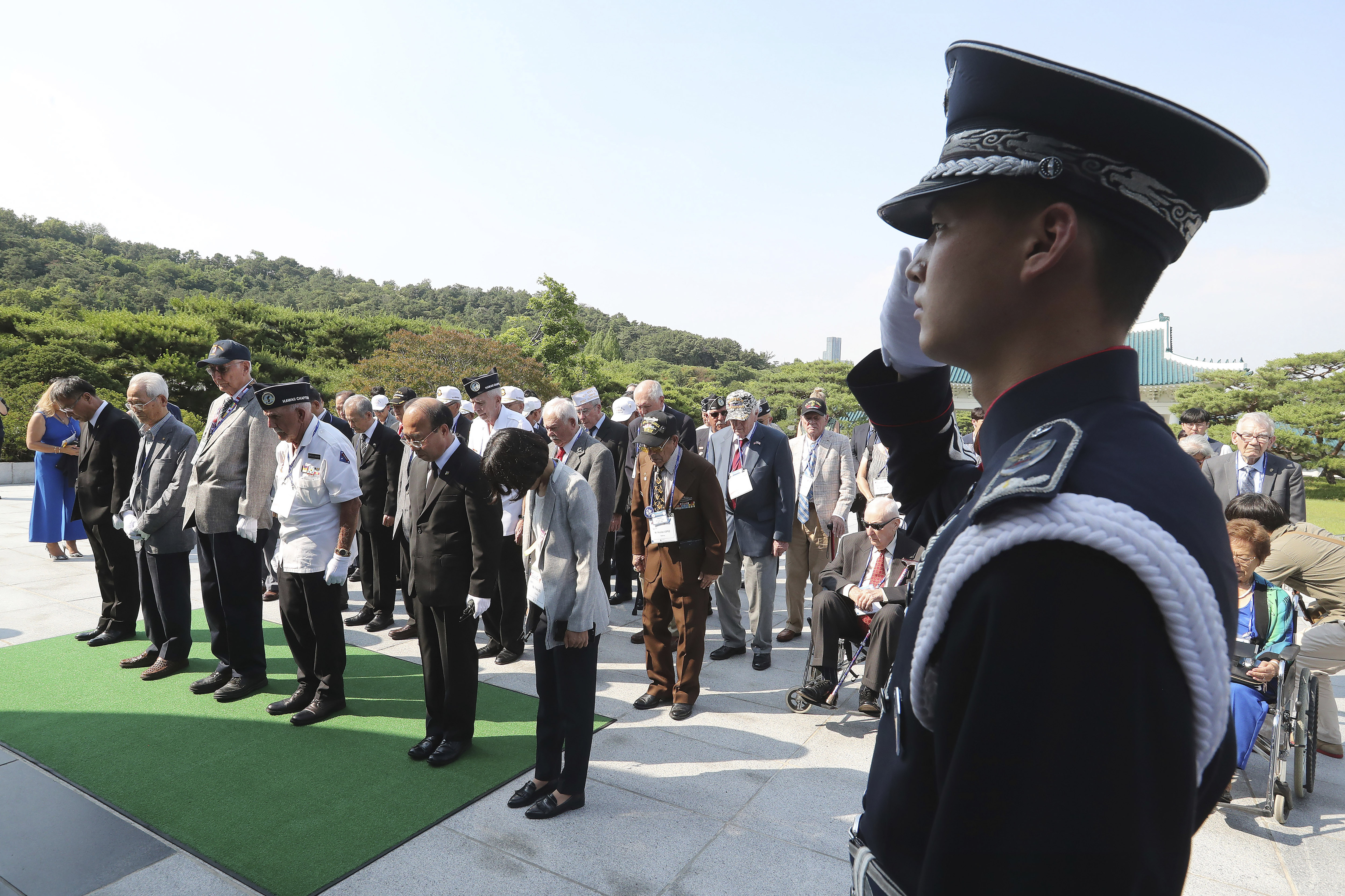 South Korean and U.S. veterans of the Korean War pay their respects to the war dead on the eve of the 69th anniversary of the outbreak of the Korean War at the National Cemetery in Seoul, South Korea, Monday, June 24, 2019. 62 U.S. war veterans and their families, along with 20 Korean veterans and their families residing overseas, arrived on Sunday, June 23, for a six-day visit to mark the anniversary. (AP Photo/Ahn Young-joon)