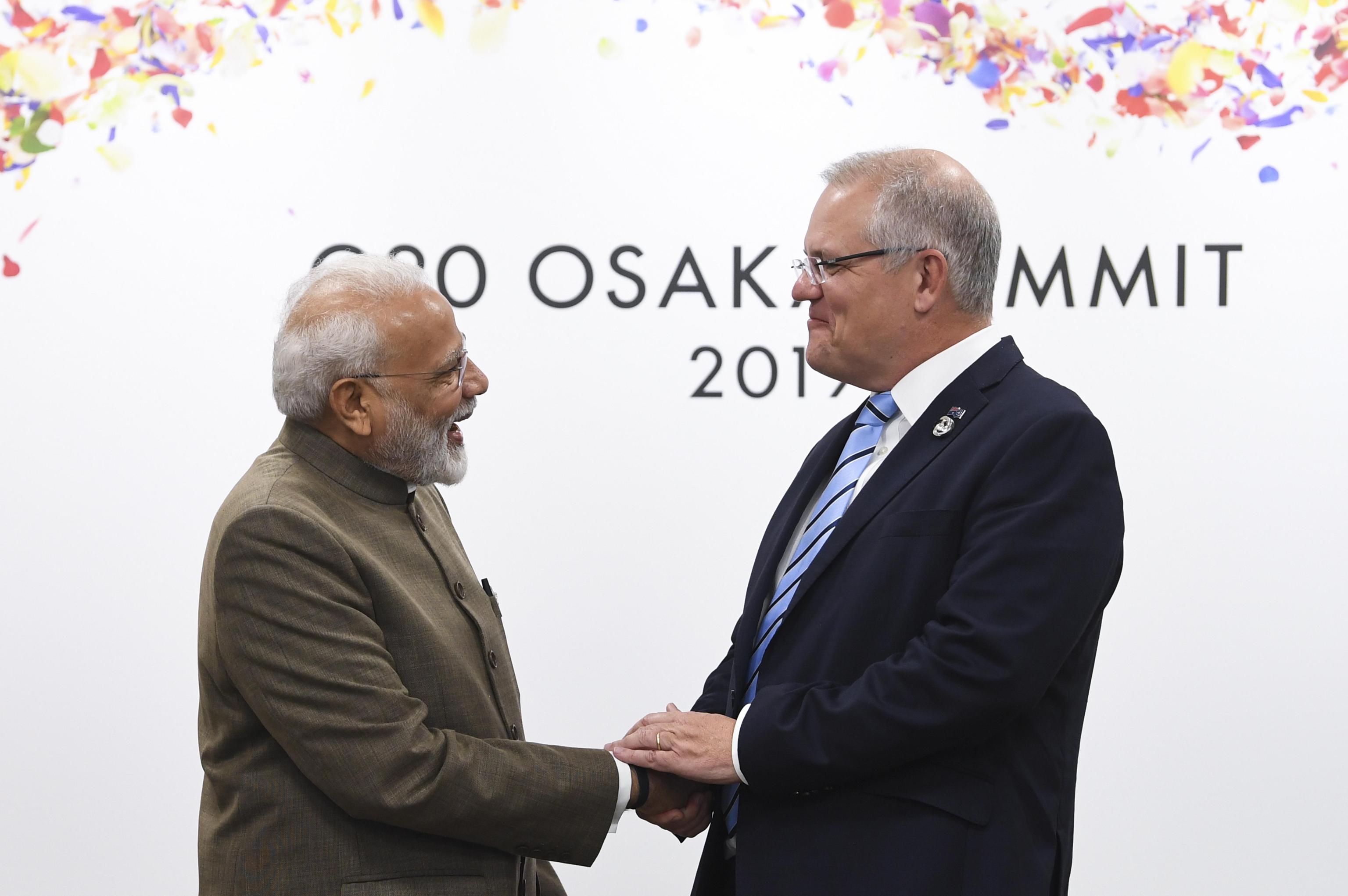epa07681613 Australian Prime Minister Scott Morrison (R) shakes hands with Indian Prime Minister Narendra Modi (L) during a bilateral meeting on the second day of the G20 summit in Osaka, Japan, 29 June 2019. It is the first time that Japan hosts a G20 summit. The summit gathers leaders from 19 countries and the European Union to discuss topics such as global economy, trade and investment, innovation and employment.  EPA/LUKAS COCH AUSTRALIA AND NEW ZEALAND OUT