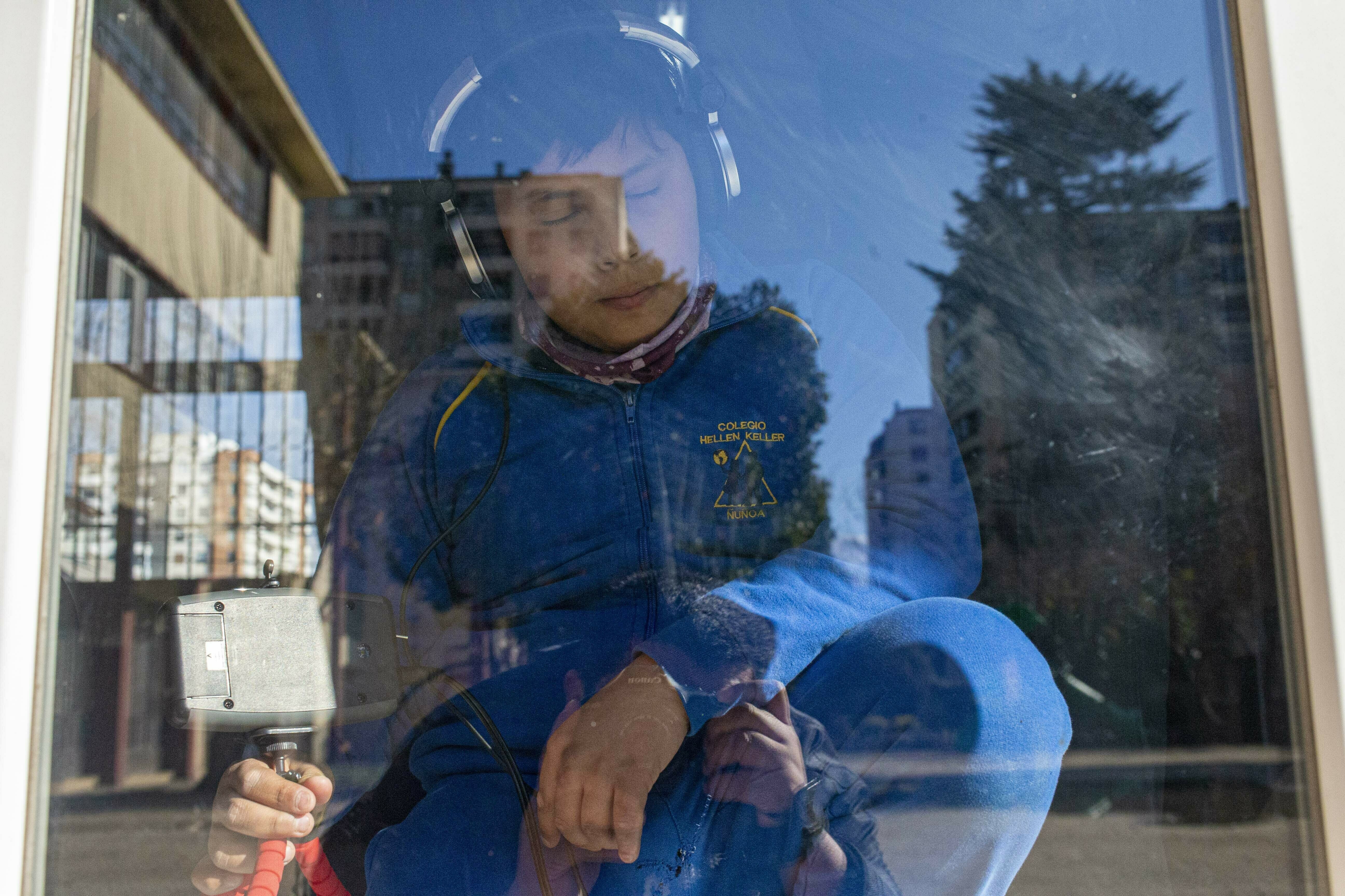 CORRECTS NAME OF UNIVERSITY - Andres Malfatti takes part in sensorial experience for blind school children, with tools created by NASA and Edinboro University of Pennsylvania to experience an eclipse, during an event in the Helen Keller school in Santiago, Chile, Tuesday, June 25, 2019. The event comes exactly one week ahead of a total solar eclipse which is set to be fully visible in various South American countries, including Chile. (AP Photo/Esteban Felix)