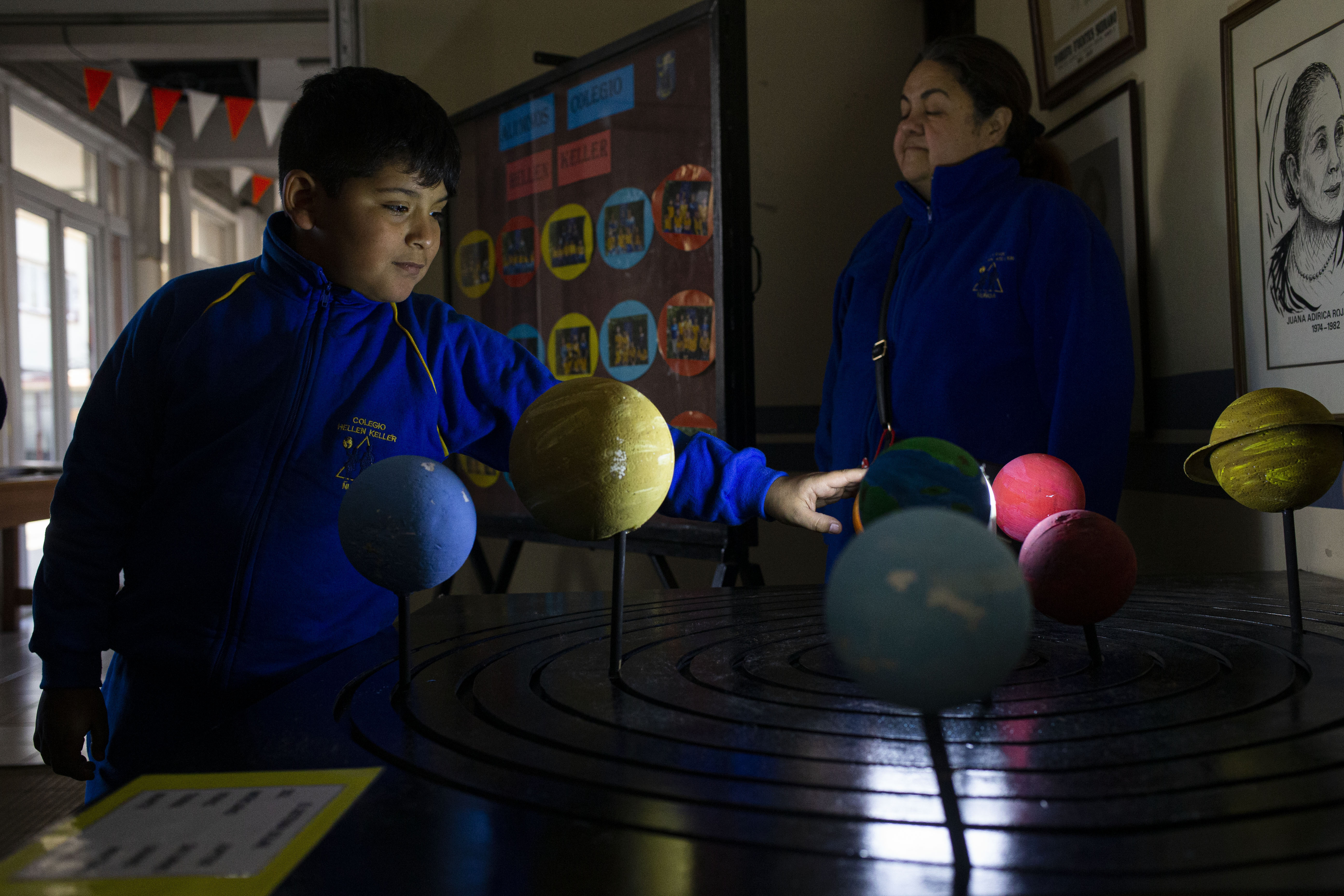 CORRECTS NAME OF UNIVERSITY - A blind child interacts with a representation of the solar system during sensorial experience with tools created by NASA and Edinboro University of Pennsylvania to experience an eclipse, at the Helen Keller school in Santiago, Chile, Tuesday, June 25, 2019. The event comes exactly one week ahead of a total solar eclipse which is set to be fully visible in various South American countries, including Chile. (AP Photo/Esteban Felix)