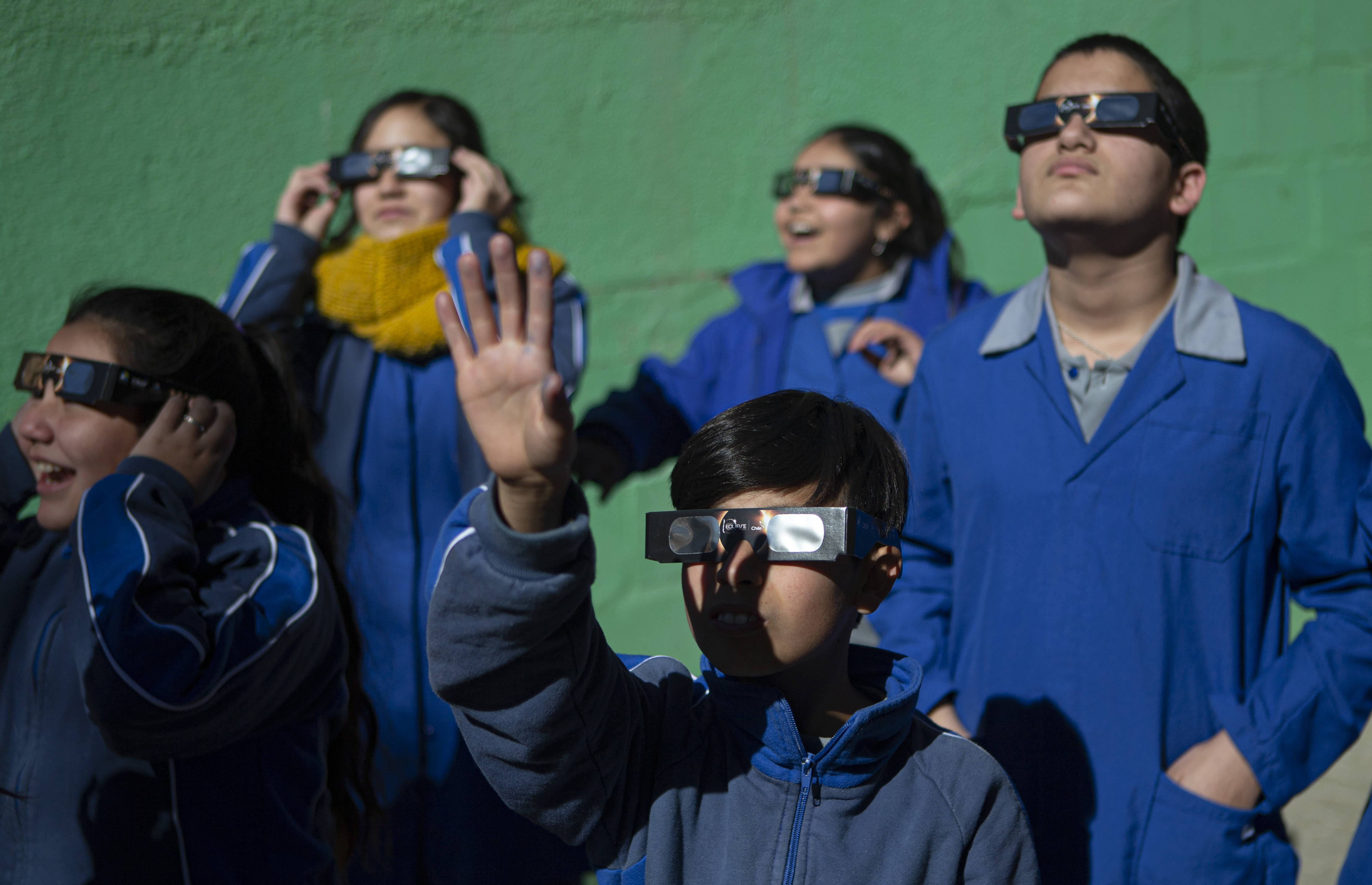 Children test on their special glasses for tomorrow's total solar eclipse at Pedro Pablo Munoz school in La Higuera, Chile, Monday, July 1, 2019. Tourists and scientists will gather in northern Chile, one of the best places in the world to watch the next the eclipse that will plunge parts of South America into darkness. (AP Photo/Esteban Felix)