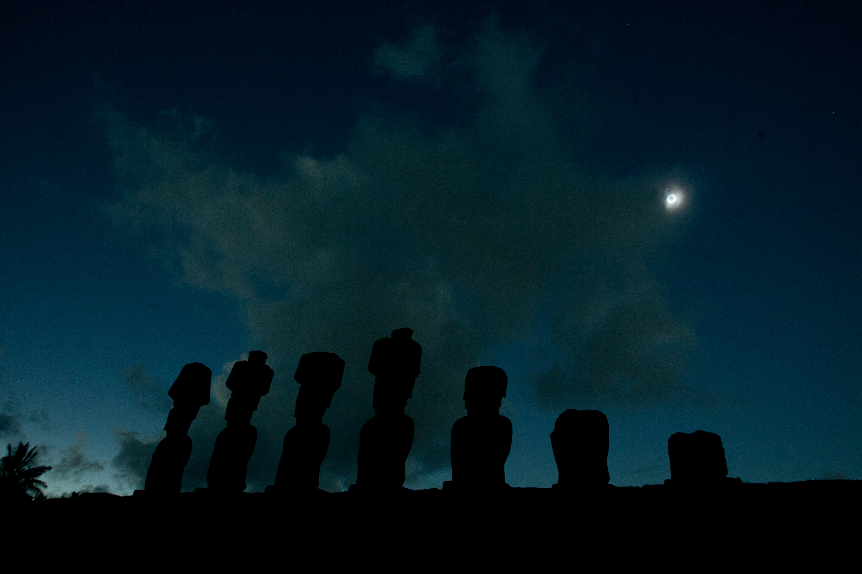Stone statues known as Moais are pictured during the total solar eclipse in Easter Island, Chile, some 4,000 km (2,480 miles) west of the Chilean coast, Sunday, July 11, 2010. (AP Photo/Patricio Munoz)