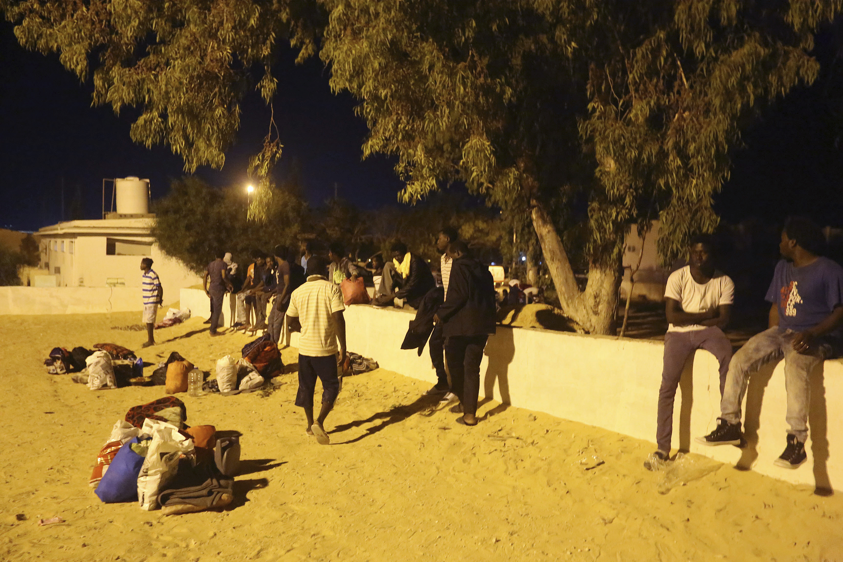 Migrants, who were not affected by an airstrike, take shelter in Tajoura, east of Tripoli Wednesday, July 3, 2019. An airstrike hit a detention center for migrants early Wednesday in the Libyan capital. (AP Photo/Hazem Ahmed)  (AP Photo/Hazem Ahmed)