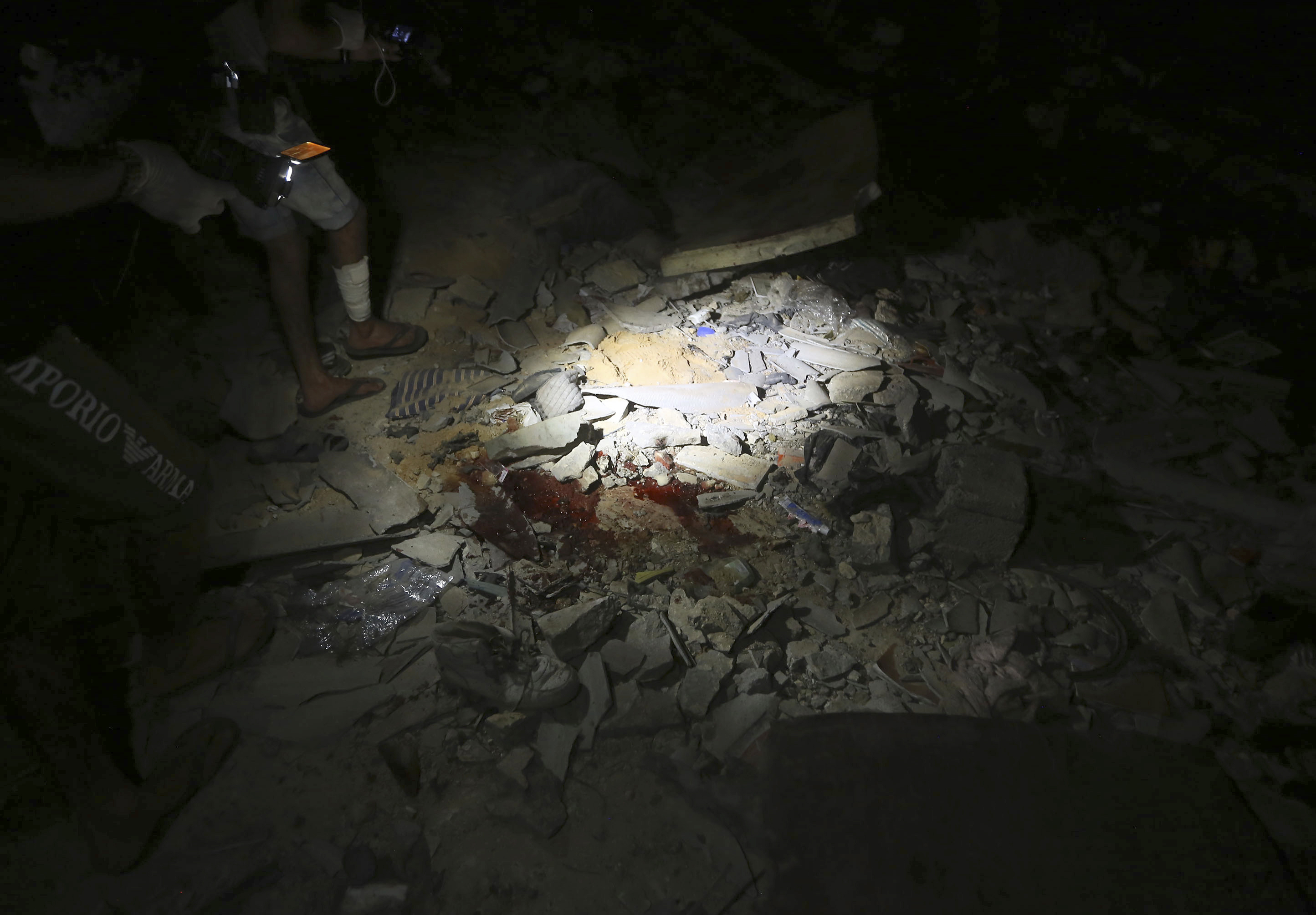 This photo shows a scene of an airstrike at a detention center in Tajoura, east of Tripoli Wednesday, July 3, 2019. An airstrike hit the detention center for migrants early Wednesday in the Libyan capital. (AP Photo/Hazem Ahmed)