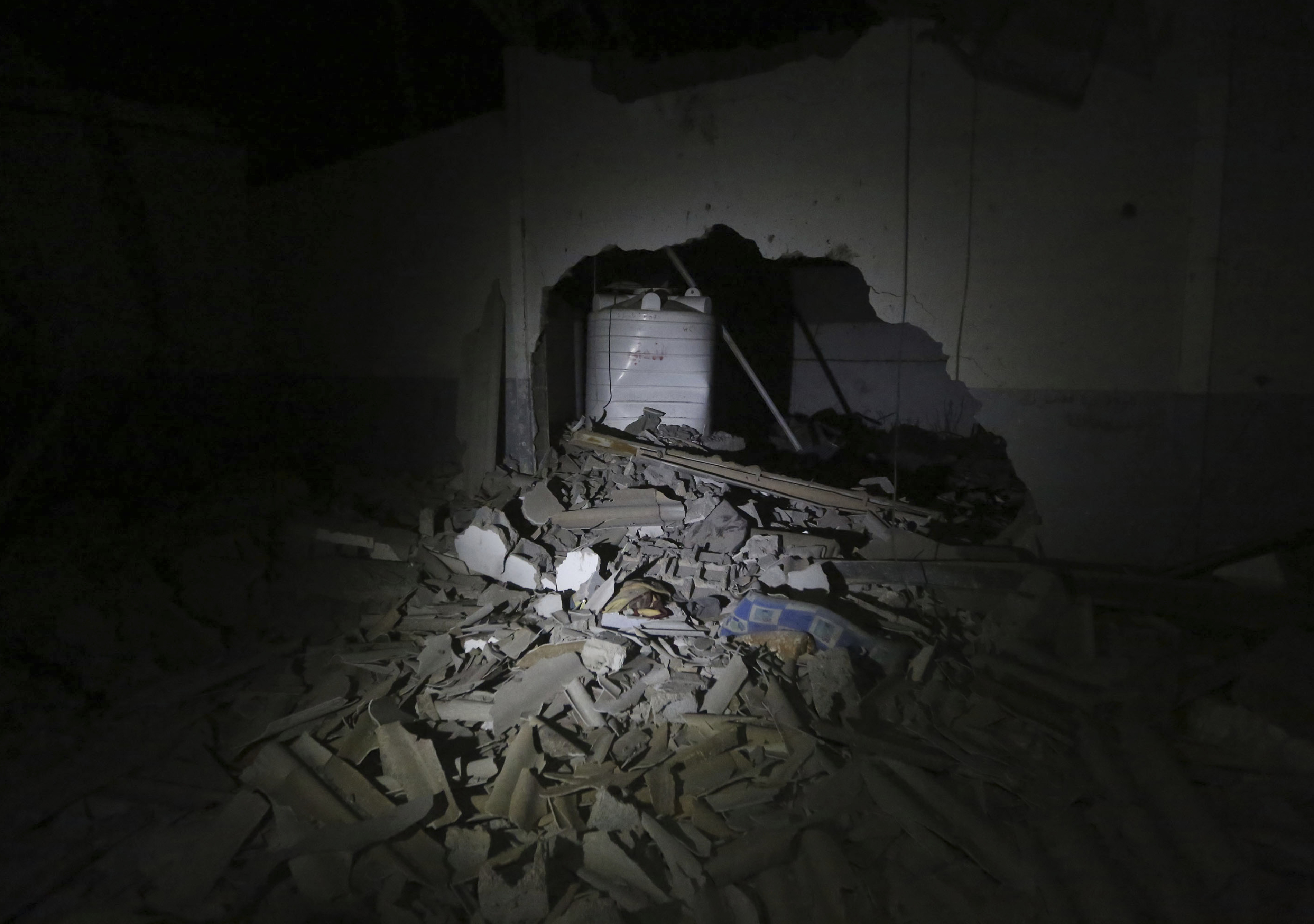 This photo shows the damages after an airstrike at a detention center in Tajoura, east of Tripoli Wednesday, July 3, 2019. An airstrike hit the detention center for migrants early Wednesday in the Libyan capital. (AP Photo/Hazem Ahmed)