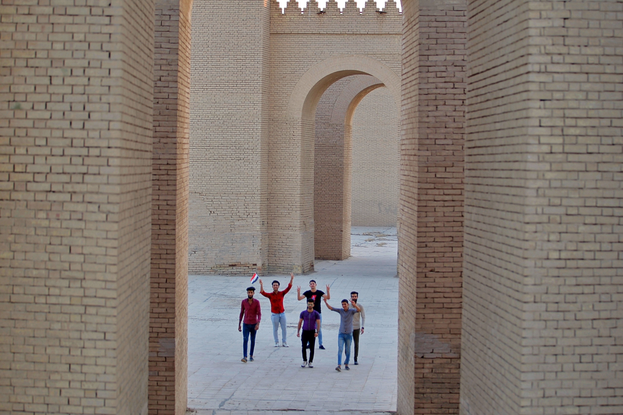 People celebrate at the archaeological site of Babylon, Iraq, Friday, July 5, 2019. Iraq on Friday celebrated the UNESCO World Heritage Committee's decision to name the historic city of Babylon a World Heritage Site in a vote held in Azerbaijan's capital, years after Baghdad began campaigning for the site to be added to the list. (AP Photo/Anmar Khalil)