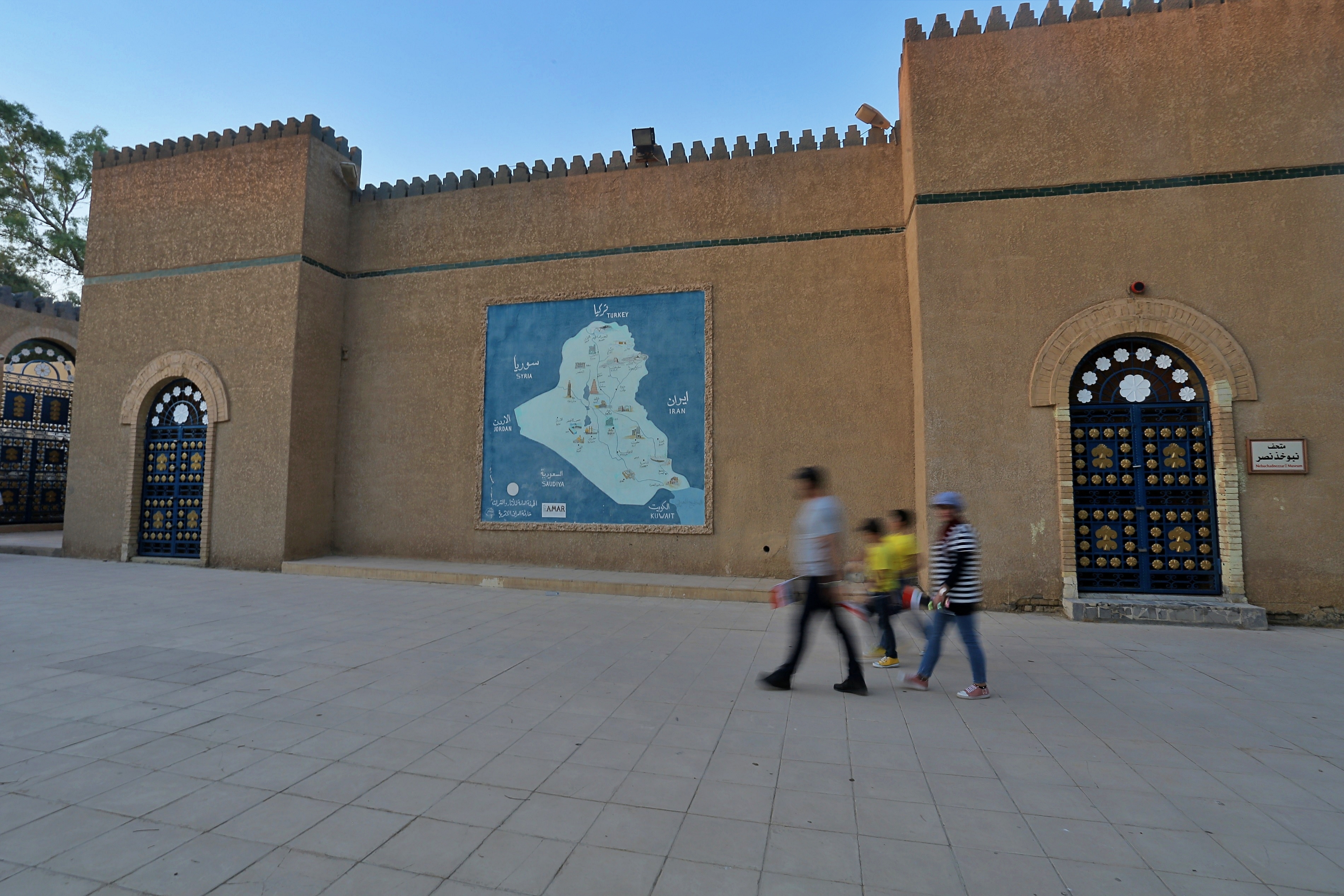 People visit the archaeological site of Babylon, Iraq, Friday, July 5, 2019. Iraq on Friday celebrated the UNESCO World Heritage Committee's decision to name the historic city of Babylon a World Heritage Site in a vote held in Azerbaijan's capital, years after Baghdad began campaigning for the site to be added to the list. (AP Photo/Anmar Khalil)