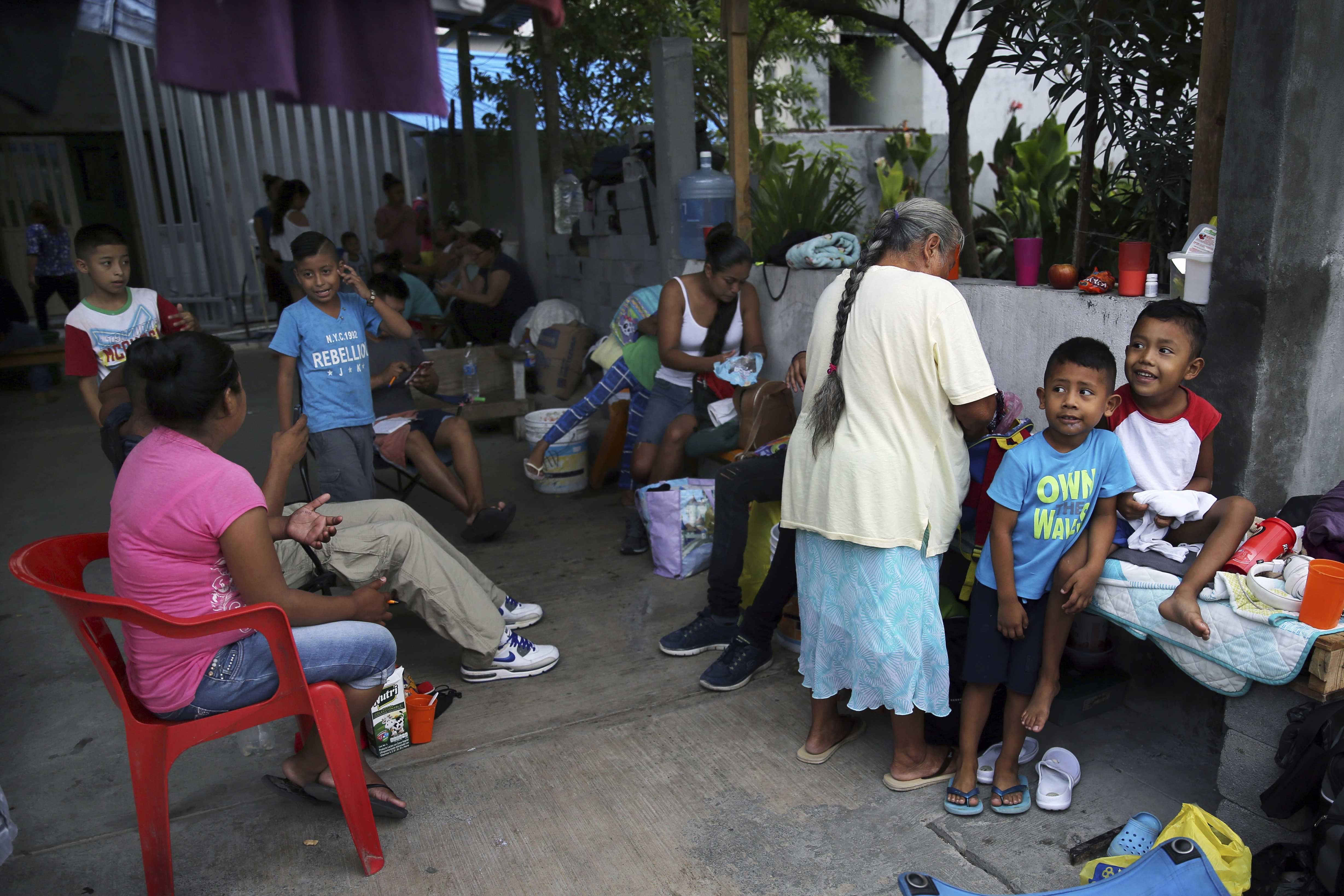 Migrants wait to be taken to the U.S. border to apply for asylum, at the AMAR migrant shelter in Nuevo Laredo, Mexico, Wednesday, July 17, 2019. Asylum-seekers grappled to understand what a new U.S. policy that all but eliminates refugee claims by Central Americans and many others meant for their bids to find a better life in America amid a chaos of rumors, confusion and fear. (AP Photo/Marco Ugarte)