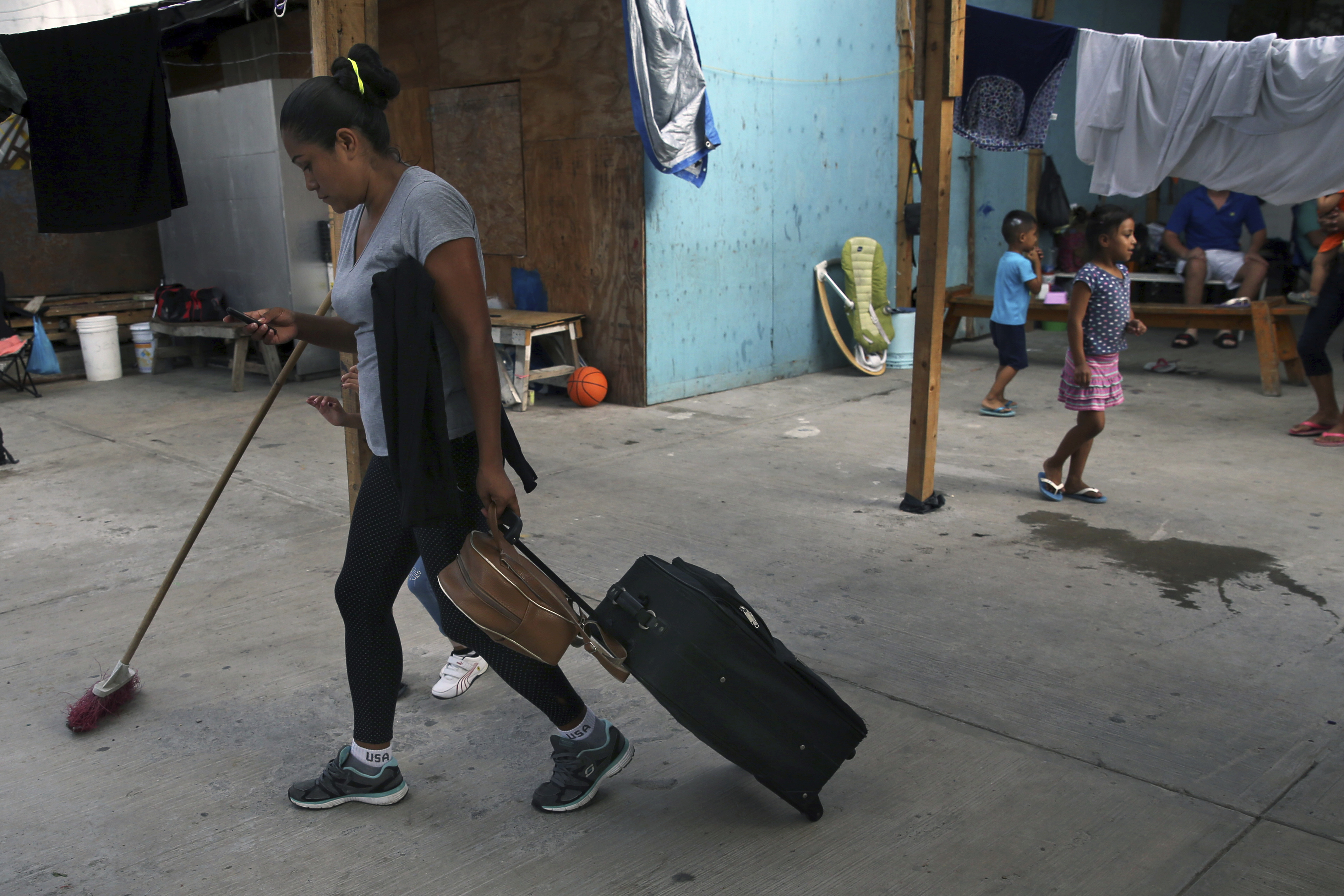 A migrant woman who was lodging at the AMAR migrant shelter get ready for a trip to the border to apply for asylum in the United States side, from Nuevo Laredo, Mexico, Wednesday, July 17, 2019. Asylum-seekers grappled to understand what a new U.S. policy that all but eliminates refugee claims by Central Americans and many others meant for their bids to find a better life in America amid a chaos of rumors, confusion and fear. (AP Photo/Marco Ugarte)