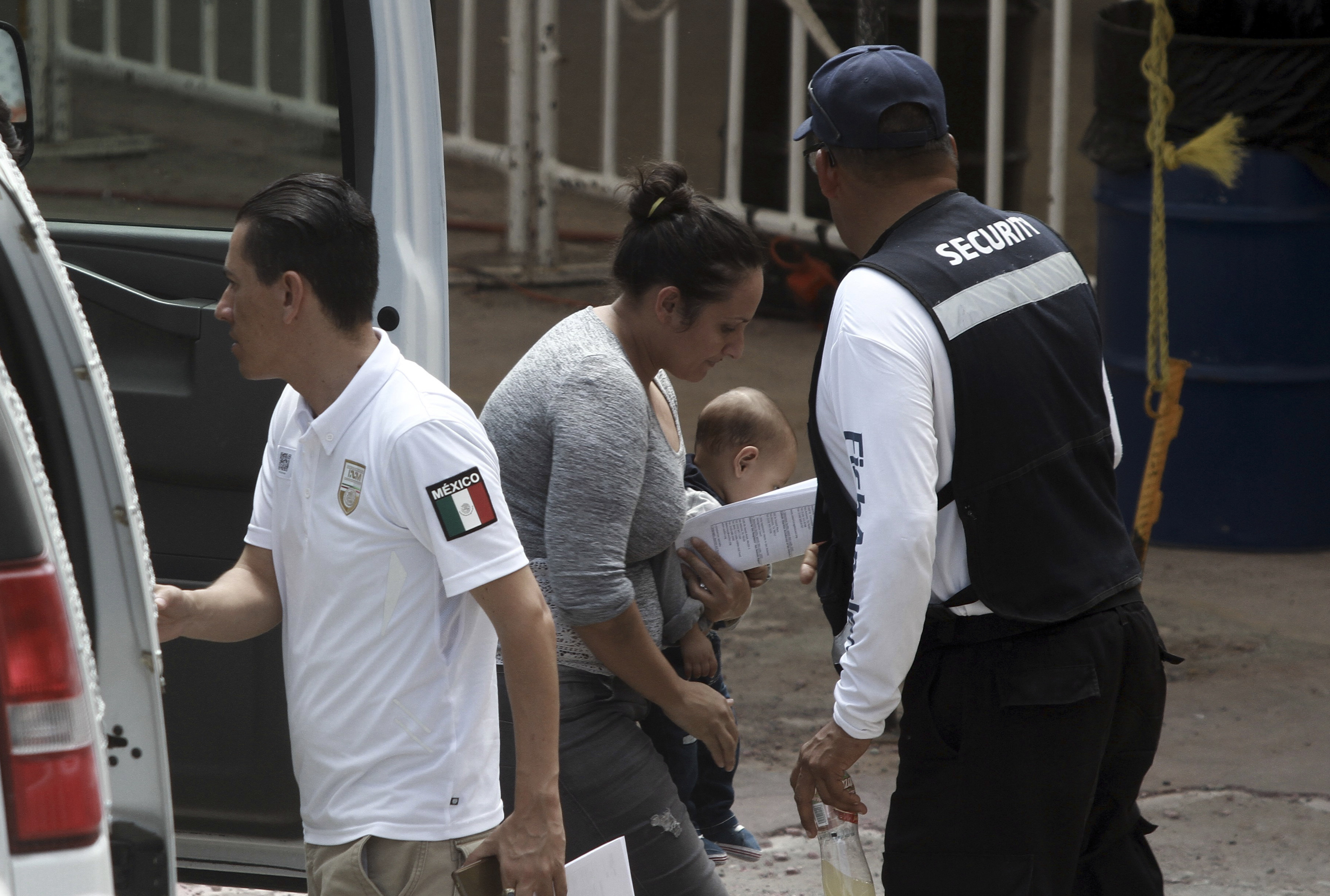 U.S. asylum-seekers walk from a van into Mexican immigration offices, after they were returned by U.S. authorities to wait in Mexico under the so-called Remain in Mexico program, in Ciudad Juarez, Mexico, Wednesday, July 17, 2019. Asylum-seekers still waiting to begin the process grappled to understand what a new U.S. policy that all but eliminates refugee claims by Central Americans and many others meant for their bids to find a better life in America.(AP Photo/Christian Chavez)