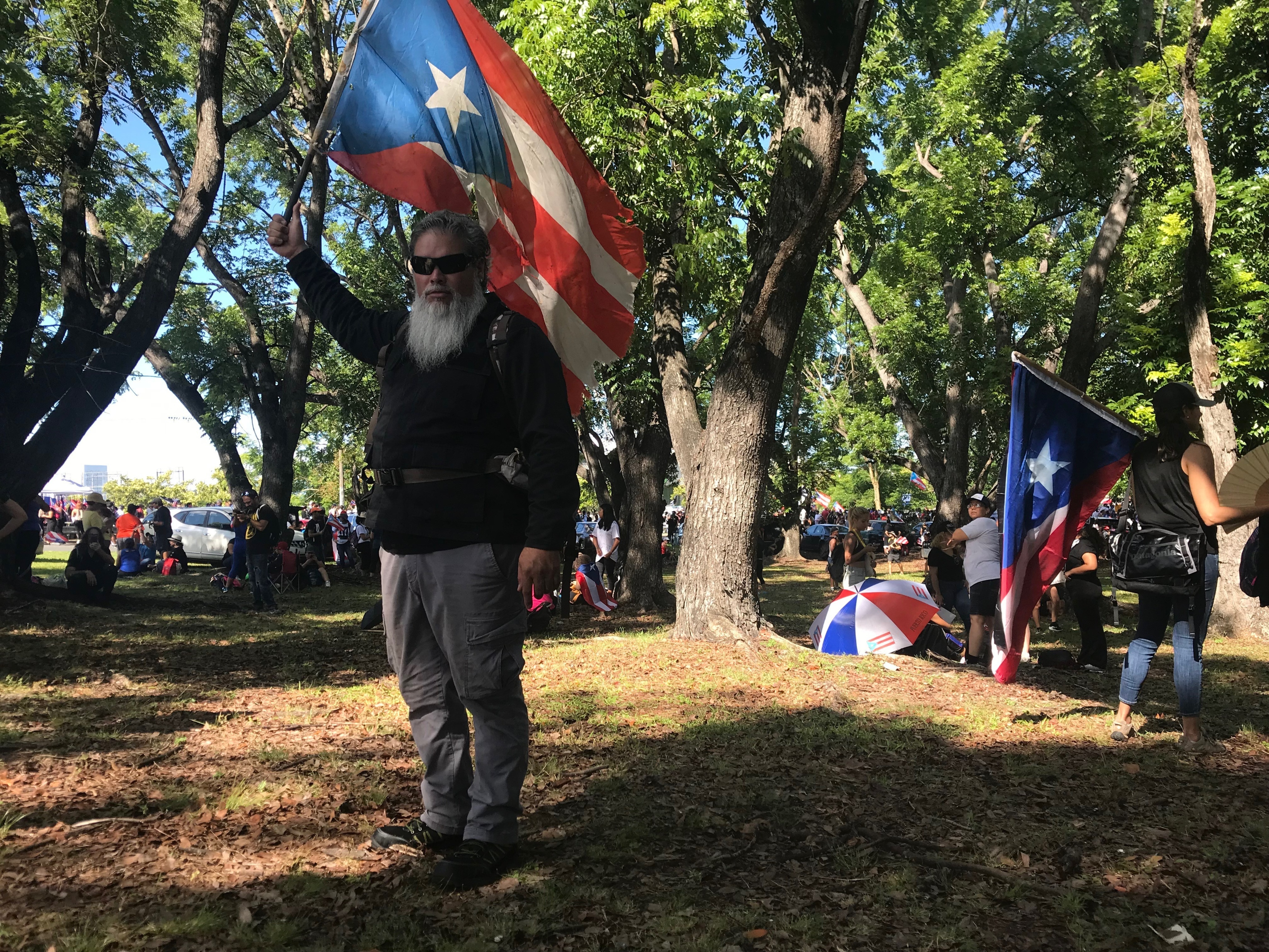 German Alejandro Ortiz, a 43-year-old businessman holds a Puerto Rico flag as he poses for a photo during a protest to demand the resignation of Governor Ricardo Rossello, in San Juan, Puerto Rico, Monday, July 22, 2019. Ortiz explained why he decided to join the protest: 