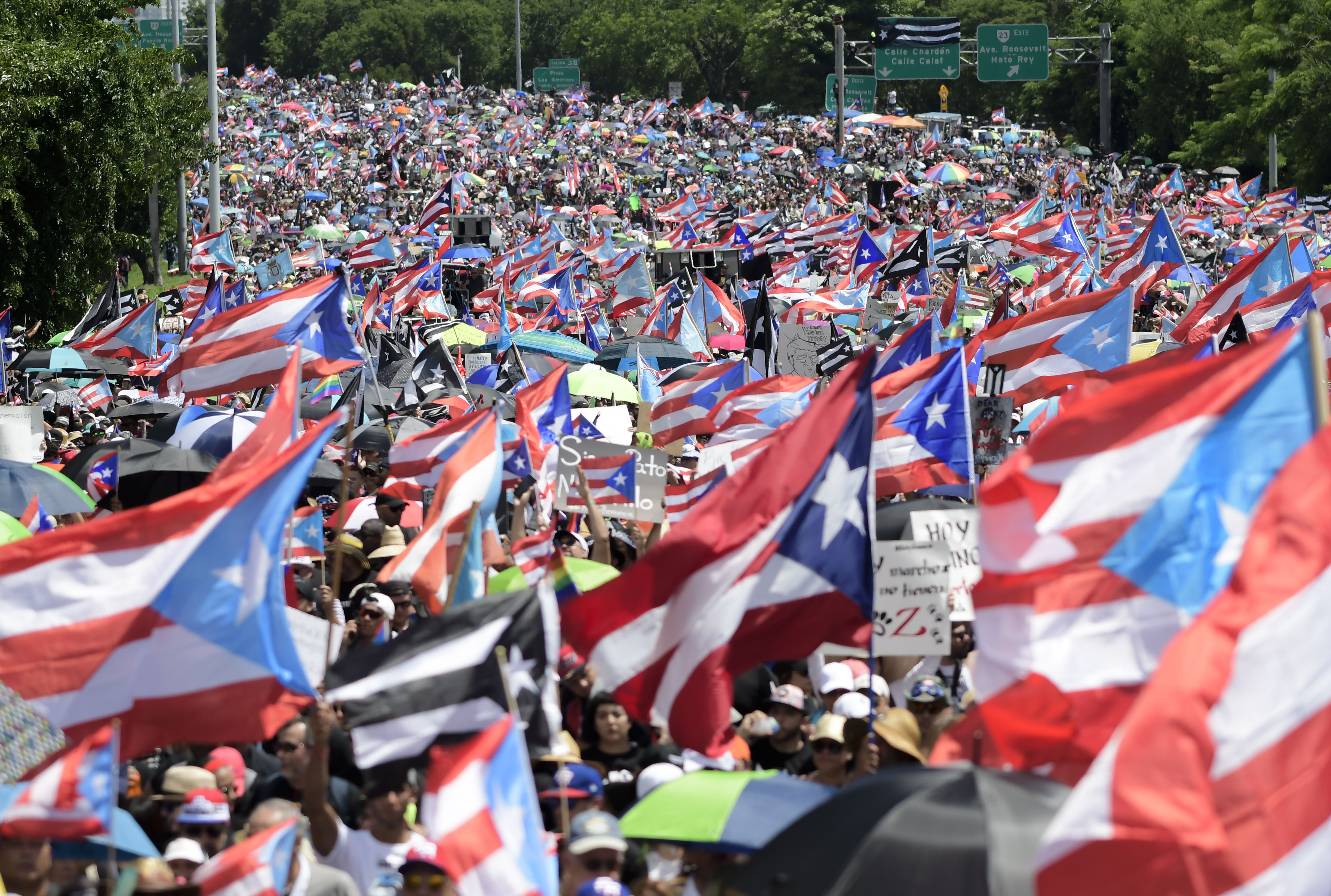 Demonstrators march on Las Americas highway demanding the resignation of governor Ricardo Rossello, in San Juan, Puerto Rico, Monday, July 22, 2019. Protesters are demanding Rossello step down for his involvement in a private chat in which he used profanities to describe an ex-New York City councilwoman and a federal control board overseeing the island's finance. (AP Photo/Carlos Giusti)