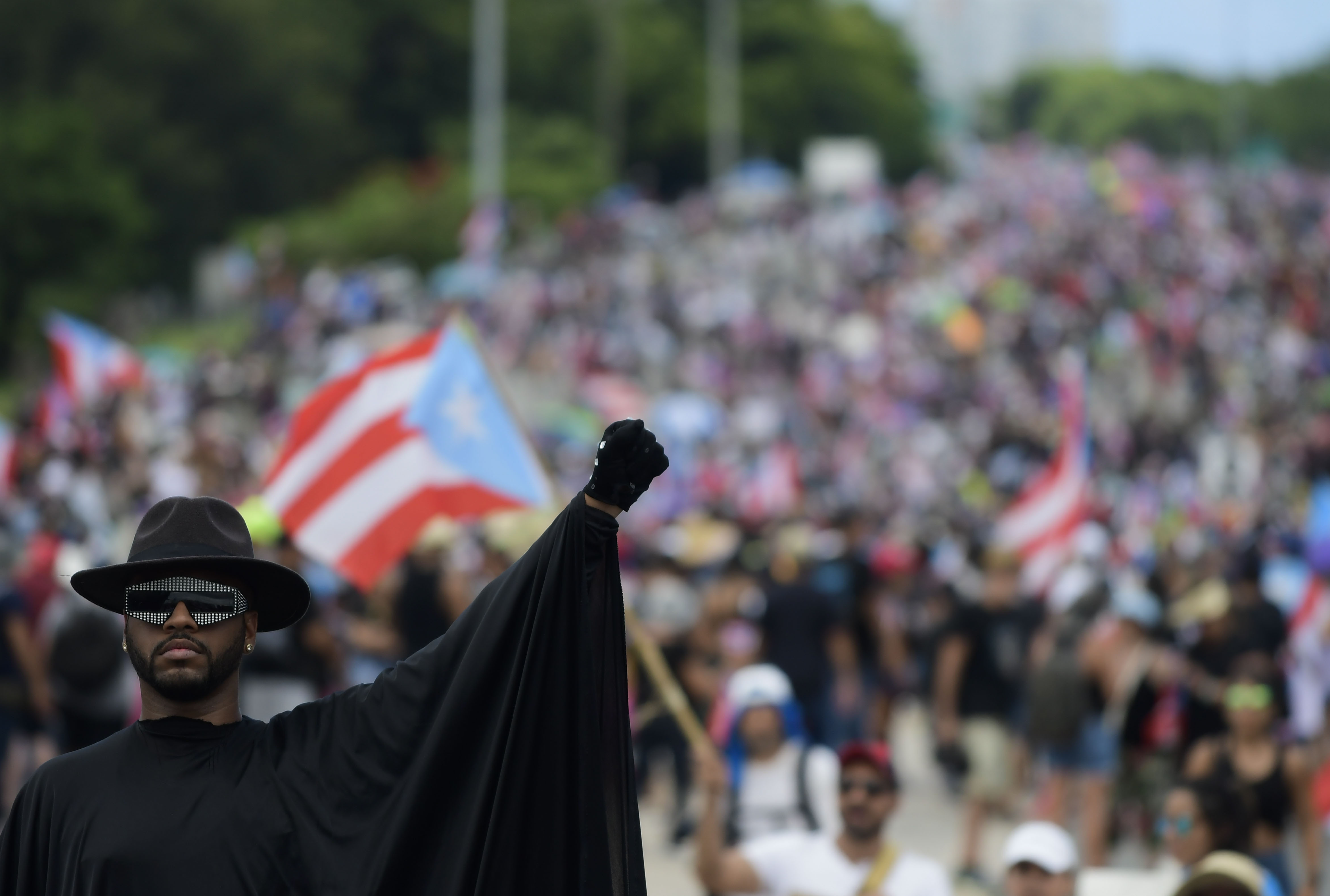 Demonstrators march on Las Americas highway during protest demanding the resignation of governor Ricardo Rossello, in San Juan, Puerto Rico, Monday, July 22, 2019. Protesters are demanding Rossello step down for his involvement in a private chat in which he used profanities to describe an ex-New York City councilwoman and a federal control board overseeing the island's finance. (AP Photo/Carlos Giusti)