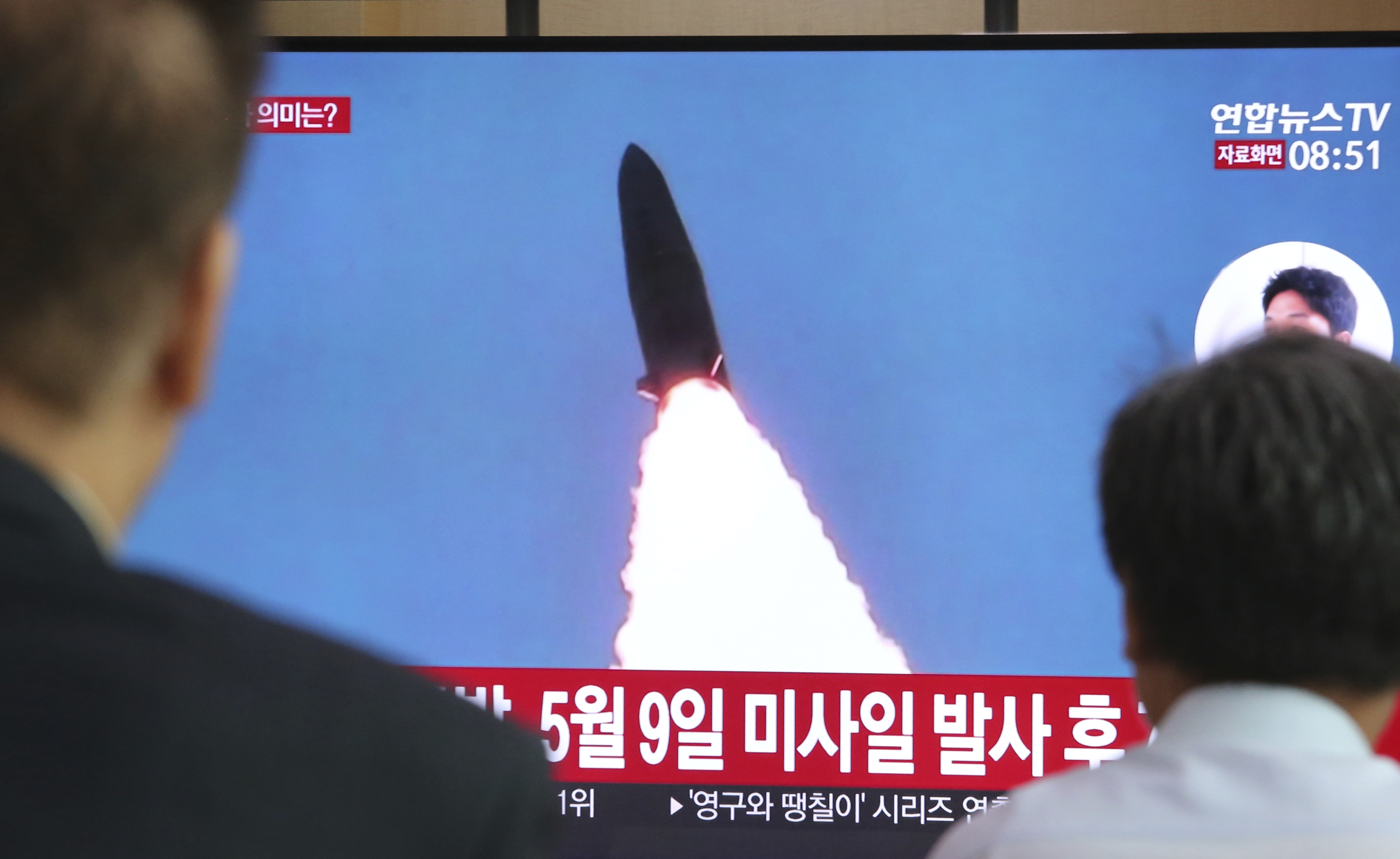 People watch a TV showing a file image of North Korea's missile launch during a news program at the Seoul Railway Station in Seoul, South Korea, Thursday, July 25, 2019. North Korea fired two unidentified projectiles into the sea on Thursday, South Korea's military said, the first launches in more than two months as North Korean and U.S. officials work to restart nuclear diplomacy. The signs read: 