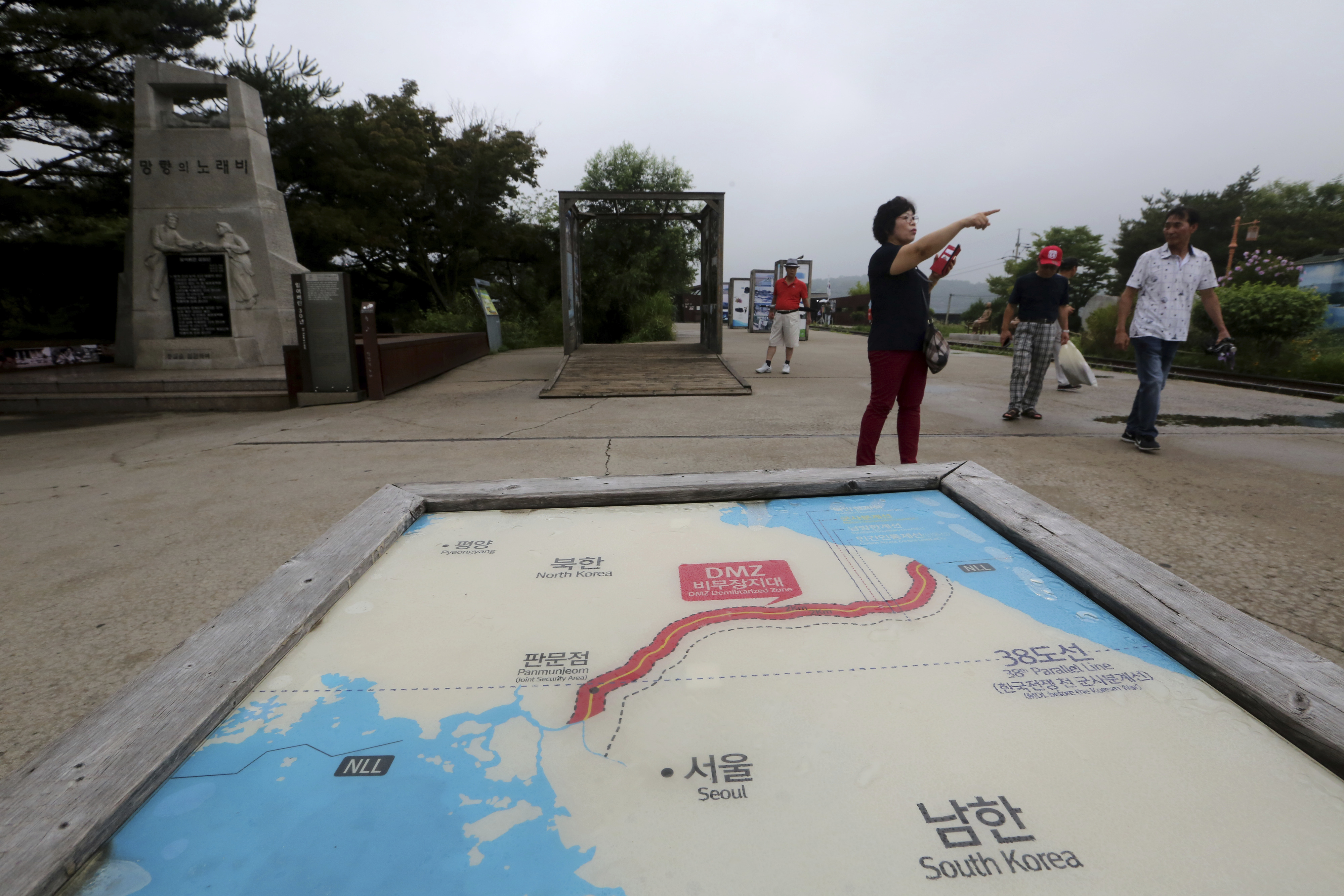 Visitors pass by a map of two Koreas showing North Korea's capital Pyongyang and South Korea's capital Seoul at the Imjingak Pavilion in Paju, South Korea, near the border with North Korea, Thursday, July 25, 2019. North Korea fired two short-range missiles into the sea Thursday, South Korea's military said, the first weapons launches in more than two months and an apparent pressuring tactic aimed at Washington as North Korean and U.S. officials struggle to restart nuclear negotiations. (AP Photo/Ahn Young-joon)