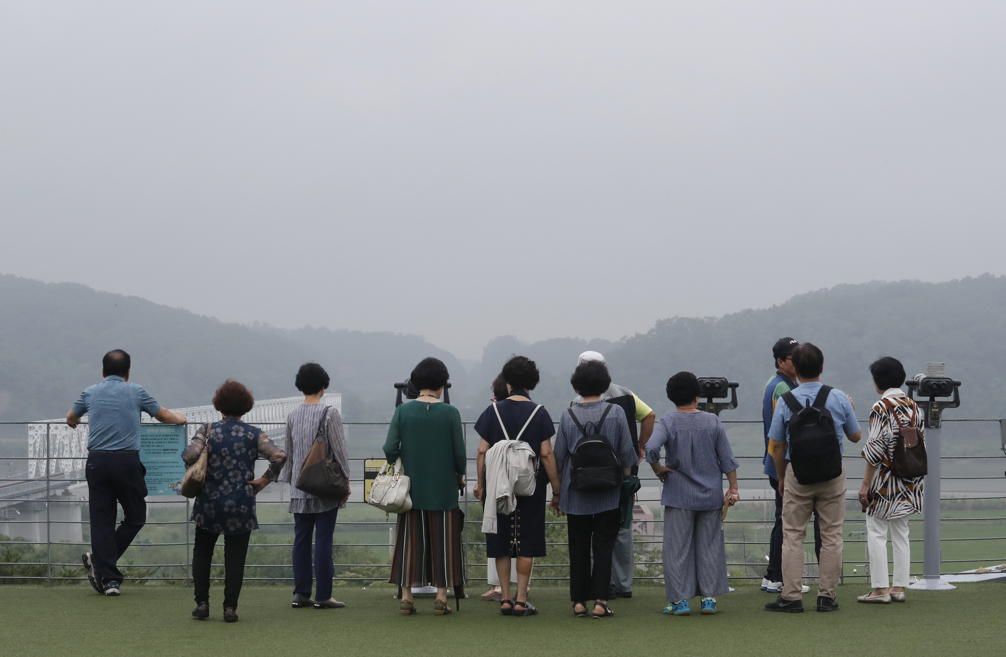 Visitors watch the North Korean side at the Imjingak Pavilion in Paju, South Korea, near the border with North Korea, Thursday, July 25, 2019. North Korea fired two short-range missiles into the sea Thursday, South Korea's military said, the first weapons launches in more than two months and an apparent pressuring tactic aimed at Washington as North Korean and U.S. officials struggle to restart nuclear negotiations. (AP Photo/Ahn Young-joon)