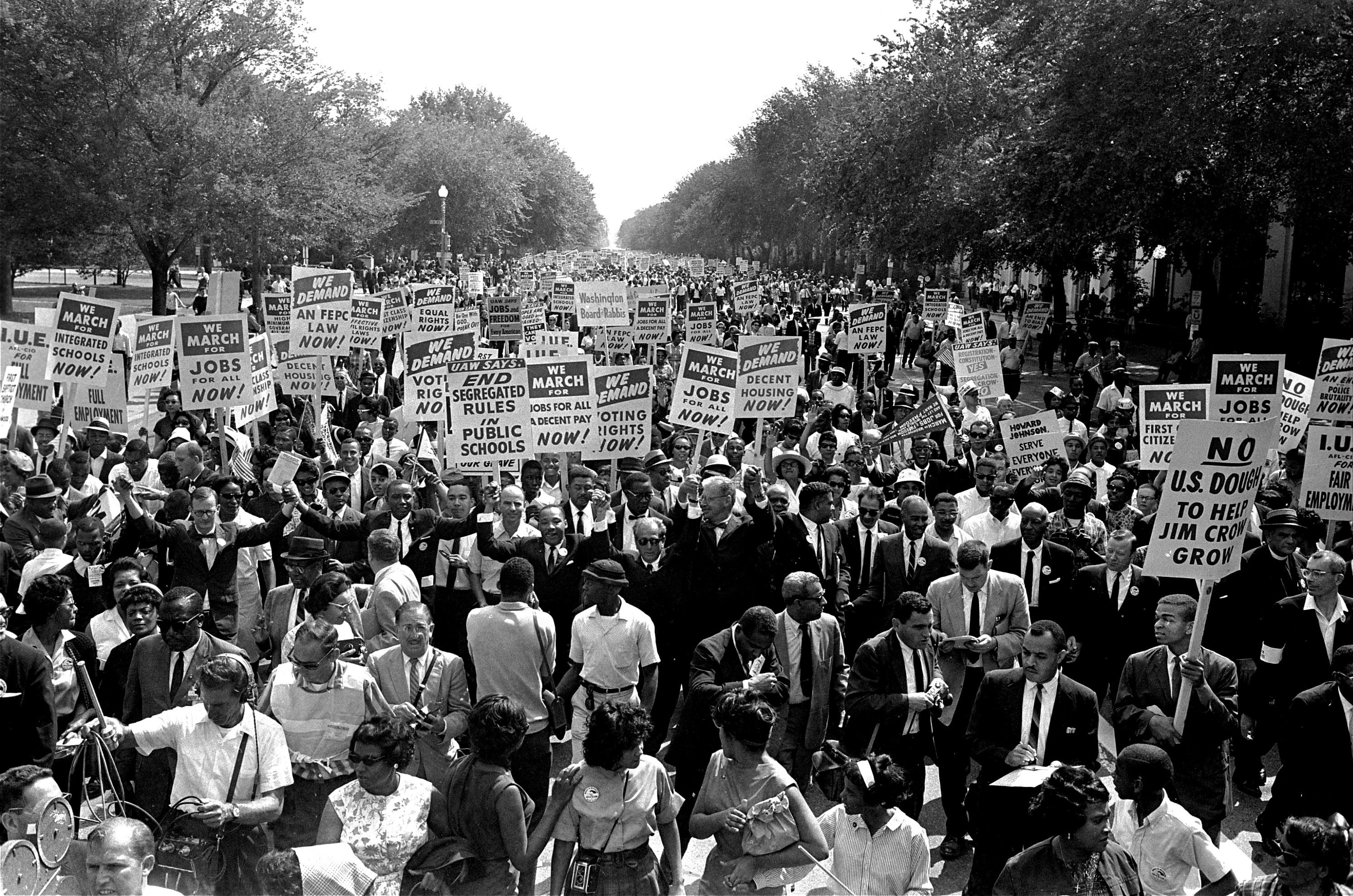 FILE - Martin Luther King Jr., center left with arms raised, marches along Constitution Avenue with other civil rights protestors carrying placards, from the Washington Monument to the Lincoln Memorial during the March on Washington on Aug. 28, 1963. (AP Photo)