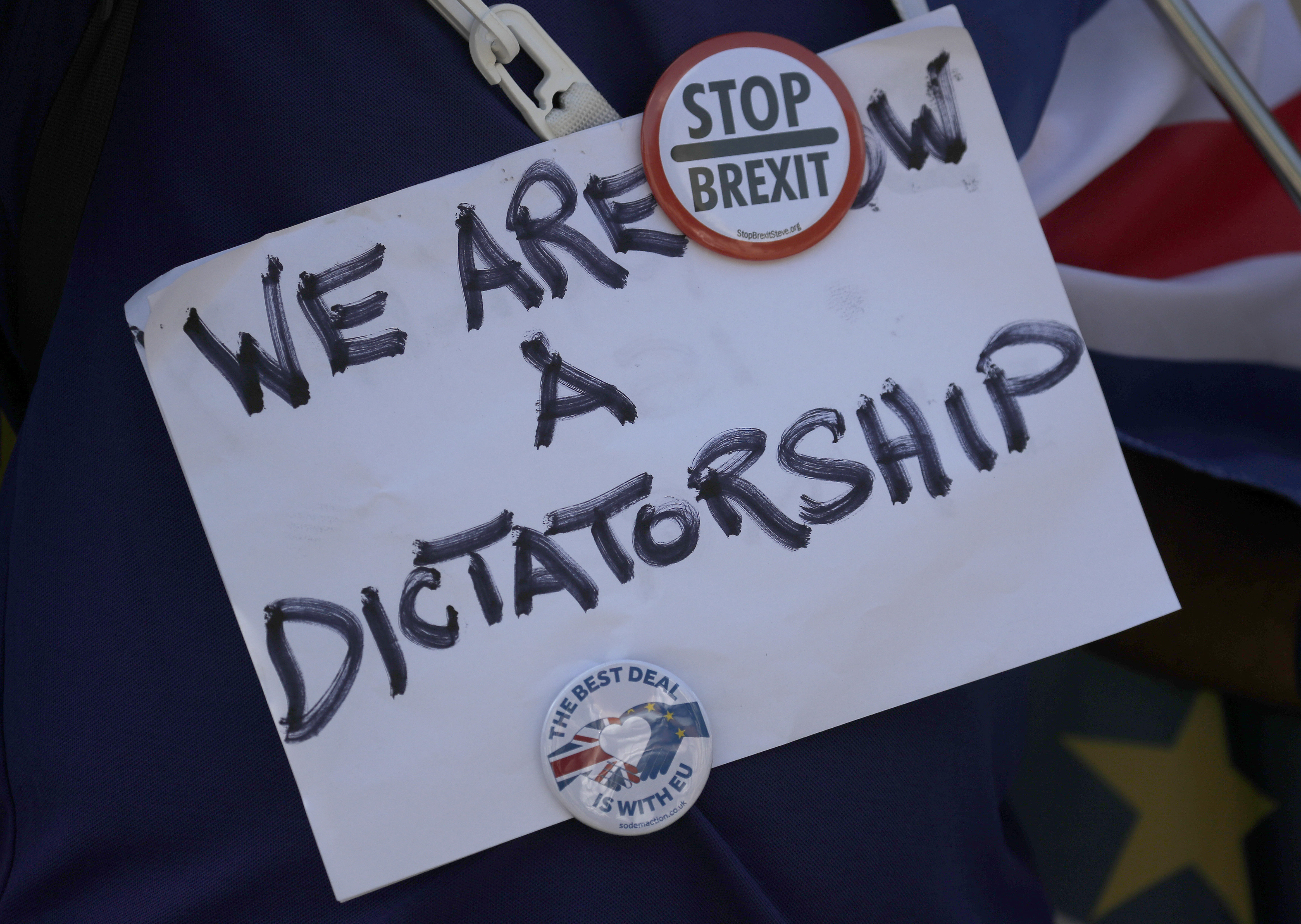 An Anti Brexit protestor shows a placard in London, Thursday, Aug. 29, 2019. Political opposition to Prime Minister Boris Johnson's move to suspend Parliament is crystalizing, with protests around Britain and a petition to block the move gaining more than 1 million signatures.(AP Photo/Frank Augstein)