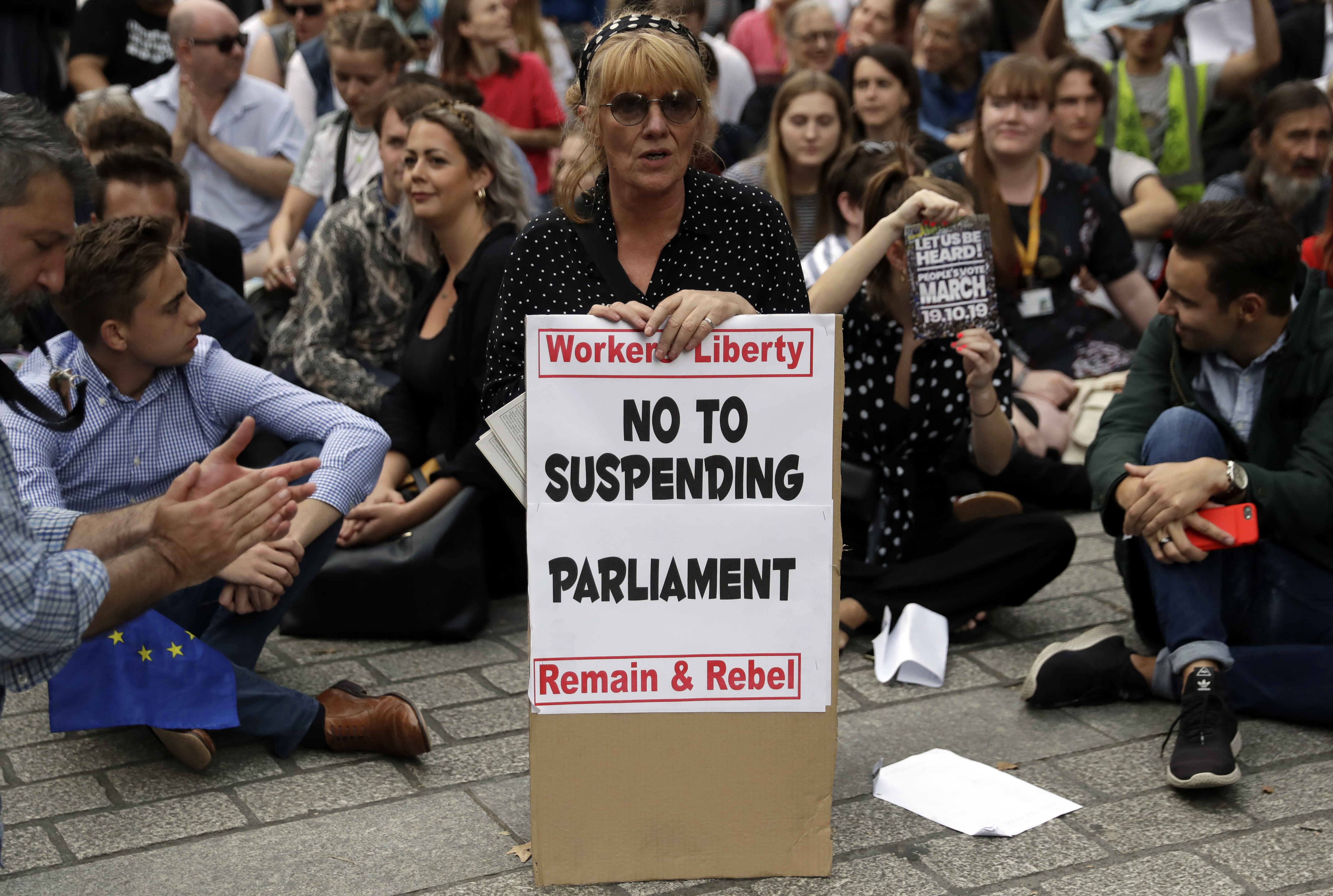 Anti-Brexit supporters gather outside the Prime Minister's residence 10 Downing Street in London, Wednesday, Aug. 28, 2019. British Prime Minister Boris Johnson asked Queen Elizabeth II on Wednesday to suspend Parliament, throwing down the gauntlet to his critics and causing outrage among opposition leaders who will have even less time to thwart a no-deal Brexit. (AP Photo/Matt Dunham)