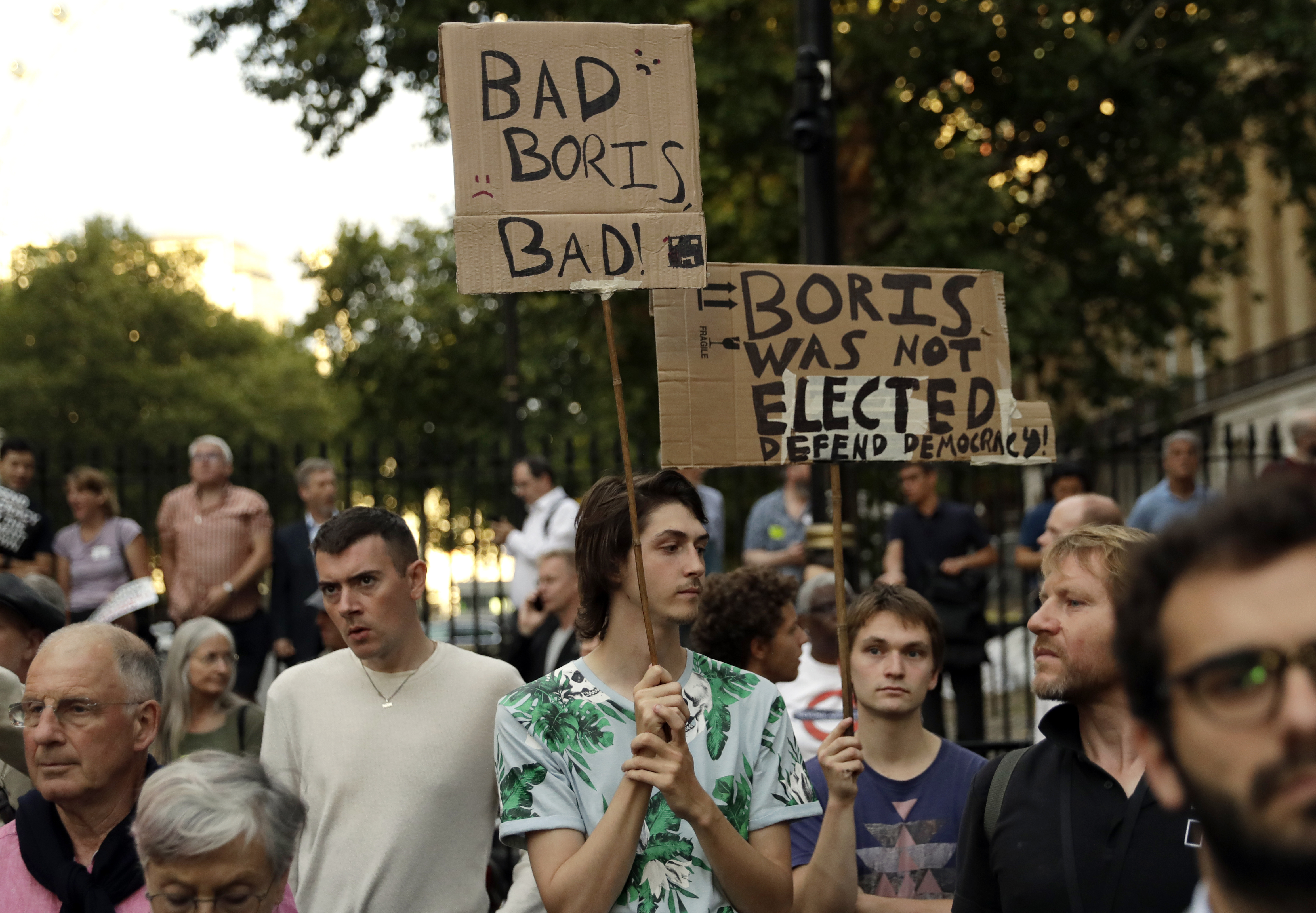 Anti-Brexit supporters gather outside the Prime Minister's residence 10 Downing Street in London, Wednesday, Aug. 28, 2019. British Prime Minister Boris Johnson asked Queen Elizabeth II on Wednesday to suspend Parliament, throwing down the gauntlet to his critics and causing outrage among opposition leaders who will have even less time to thwart a no-deal Brexit. (AP Photo/Matt Dunham)