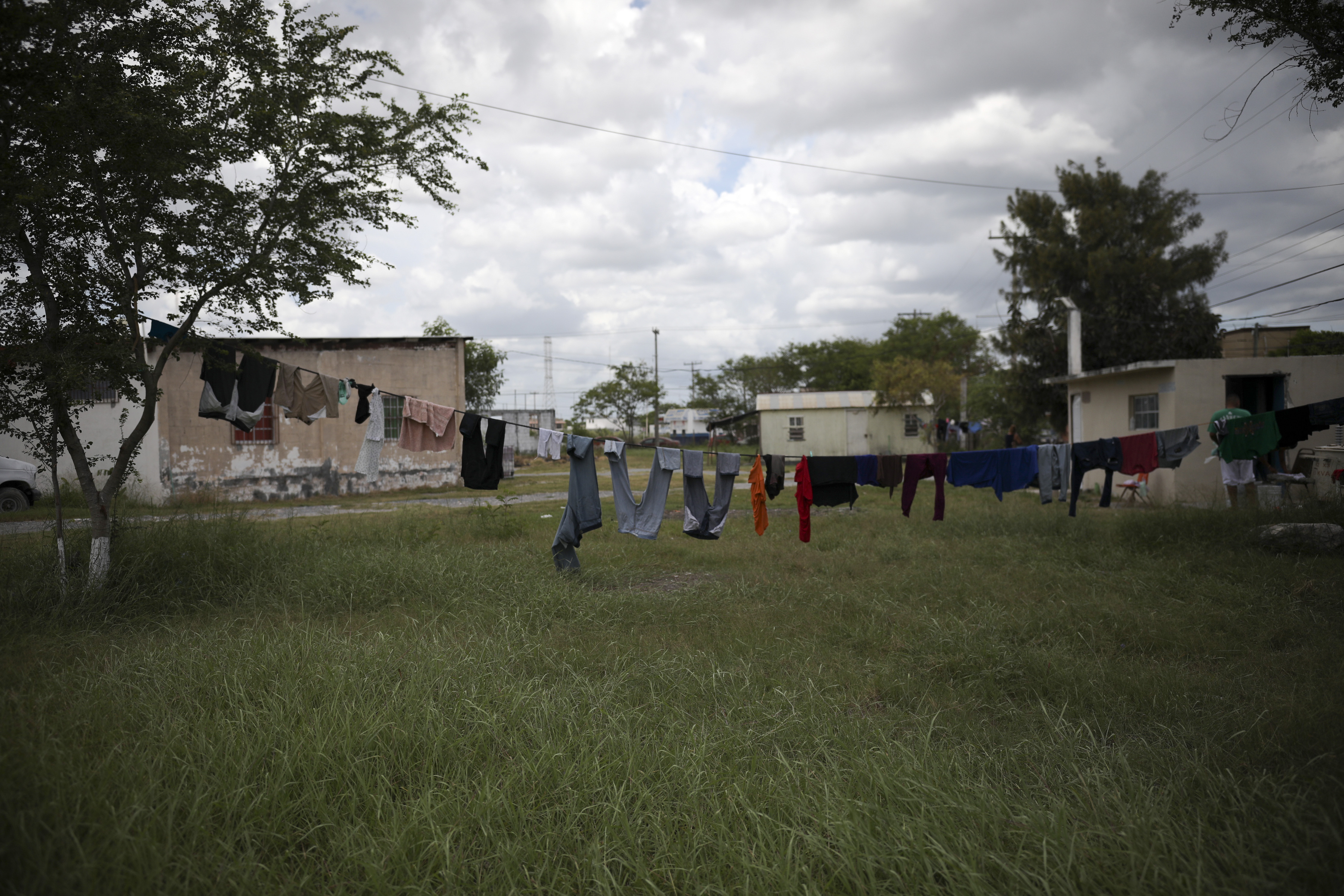 Recently washed clothes from migrants hang to dry outside the Viento Recio church, which is serving as a migrant shelter, in Matamoros, Mexico, Thursday, Aug. 1, 2019, on the border with Brownsville, Texas. So far more than 20,000 migrants have been returned to wait in Mexico for their U.S. asylum applications to be processed, according to Mexican authorities. (AP Photo/Emilio Espejel)