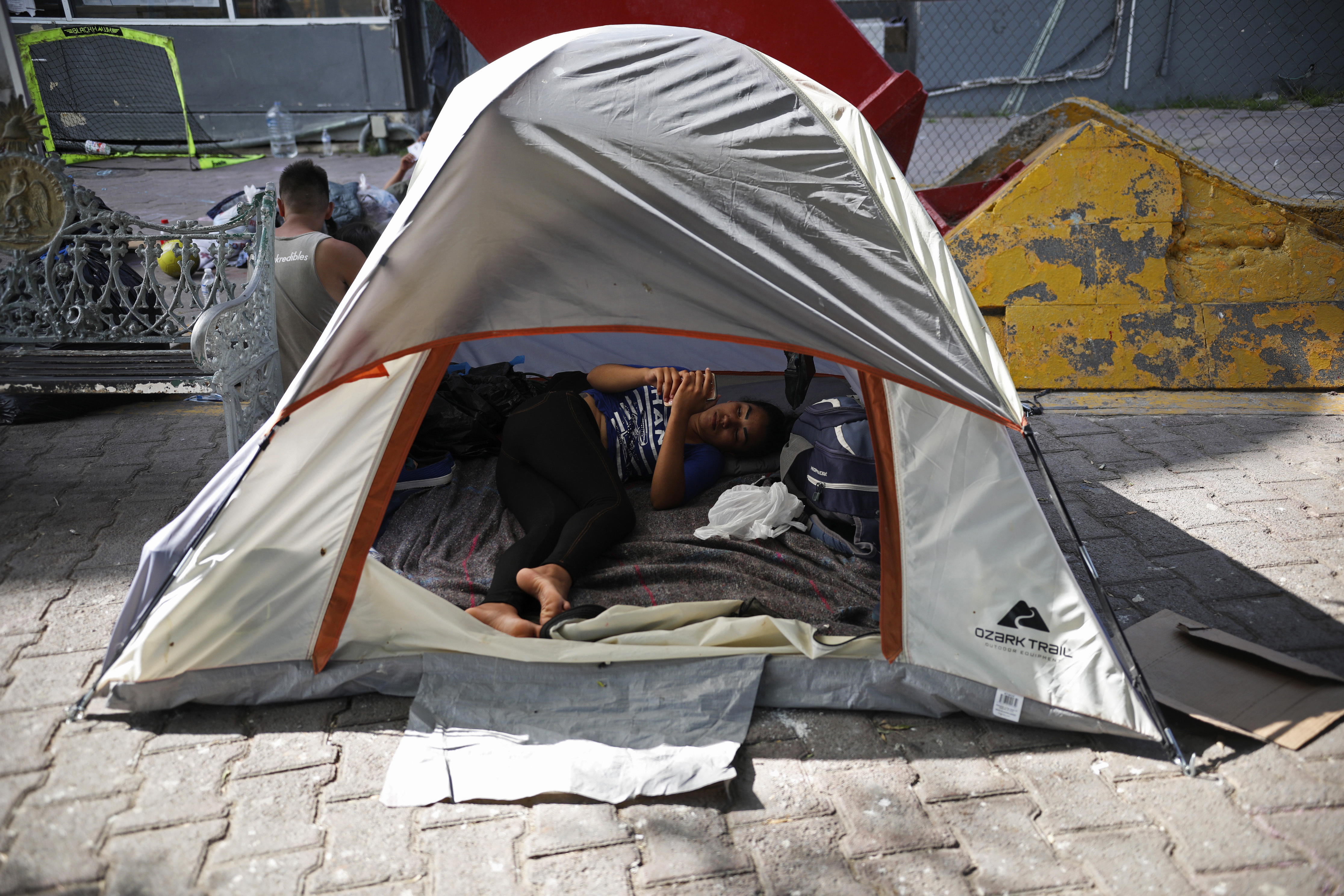 A migrant rests inside a tent pitched near a Mexican immigration center where people have set up camp to sleep in Matamoros, Mexico, Thursday, Aug. 1, 2019, on the border with Brownsville, Texas. The United States government has sent some 800 mostly Central American and Cuban immigrants back to this northern Mexico border city since expanding its controversial plan to this easternmost point on the shared border two weeks ago, according to local Mexican authorities. (AP Photo/Emilio Espejel)