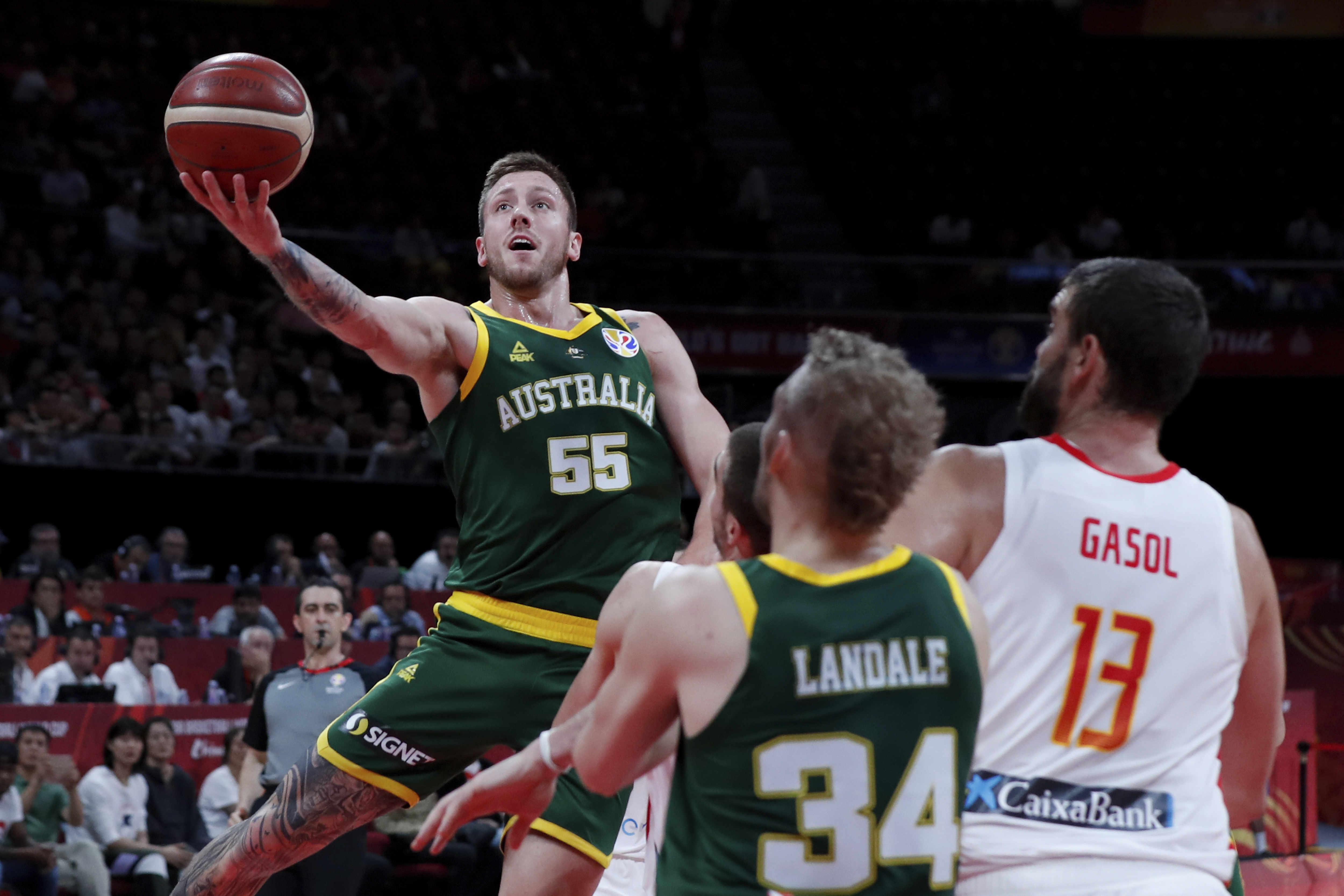 Mitch Creek of Australia puts a shot over Spain during their semifinals match for the FIBA Basketball World Cup at the Cadillac Arena in Beijing, Saturday, Sept. 13, 2019. (AP Photo/Andy Wong)